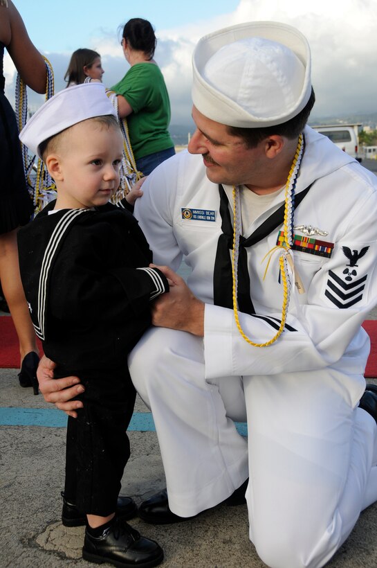 U.S. Navy 1st Class Steven Bear hugs his son during a homecoming celebration for the Los Angeles-class submarine USS Louisville at Joint Base Pearl Harbor-Hickam, Oct. 29, 2010. 