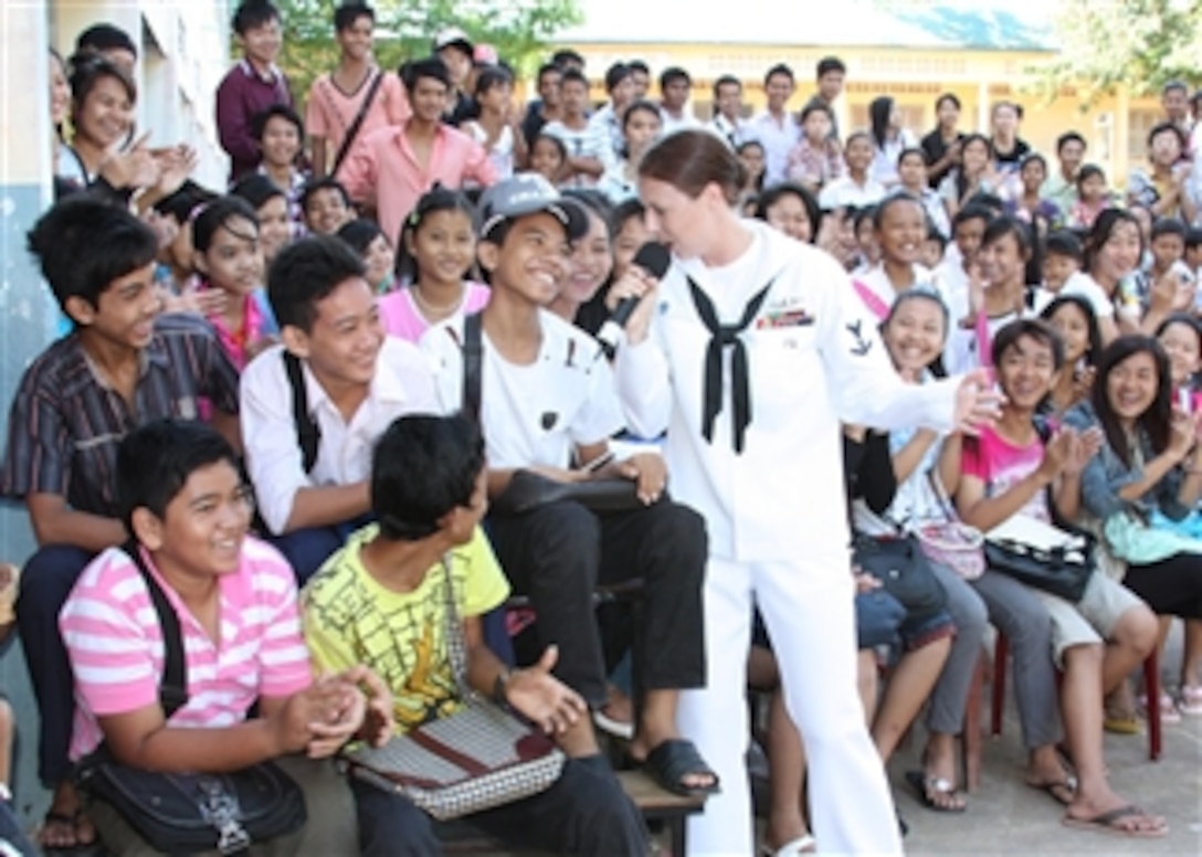 U.S. Navy Petty Officer 3rd Class Nina Church (center) sings to students at a high school in Sihanoukville, Cambodia, on Oct. 29, 2010.  Church is participating in Cooperation Afloat Readiness and Training Cambodia 2010, part of a series of bilateral exercises in Southeast Asia.  