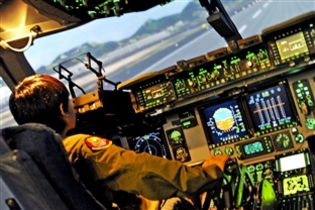 Ryder Lum, 11, flies a C-17 Globemaster III simulator during his visit to Joint Base Pearl Harbor-Hickam, Hawaii, Oct. 29, 2010. Ryder was part of the 535th Airlift Squadron's quarterly Pilot for a Day program, which allows children with catastrophic disorders or illnesses to experience a day in the life of an Air Force pilot.