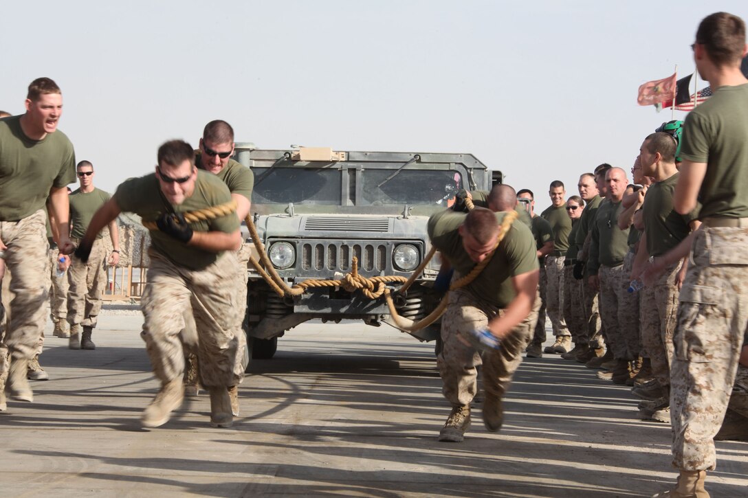 Marines of Marine Heavy Helicopter Squadron 362, 3rd Marine Aircraft Wing (Forward), pull a High Mobility Multipurpose Wheeled Vehicle during one of the events held during the Ugly Games.  The Marines raced against the clock to see who could pull the HMMWV 75 meters the fastest.  The Marines have worked 65 days without a day off since their arrival in September and the squadron hosted the event to give Marines a break from their day-to-day work routine.