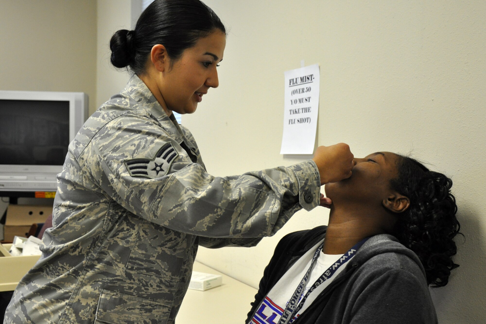 Technical Sgt. Kiwinana A. Crow, a war readiness management technician with the 917th Logistics Readiness Squadron, receives the mist injection of the flu vaccine from Senior Airman Catarina Rose, a medical technician with the 917th Medical Squadron, at the medical squadron building on Barksdale Air Force Base, La., Nov. 4, 2010. Sergeant Crow is also an Air Reserve Technician (ART) for the 917th Wing. Unlike the “flu shot,” which is an inactivated (killed) vaccine injected into the muscle, the flu mist, is a live, attenuated (weakened) influenza vaccine sprayed into the nostrils. Influenza viruses are always changing. Because of this, influenza vaccines are updated every year, and an annual vaccination is recommended, but is mandatory for the military. It takes up to two weeks for protection to develop after the shot, and protection lasts up to a year. (U.S. Air Force photo/Tech. Sgt. Jeff Walston) 