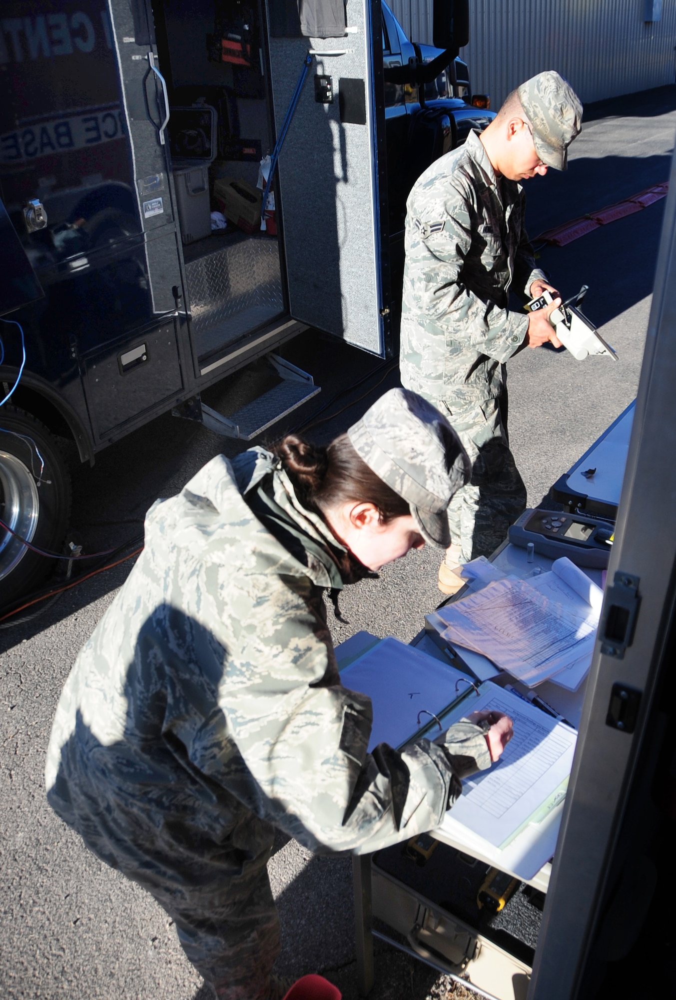ELLSWORTH AIR FORCE BASE, S.D. - Airman 1st Class Matthew Hung, 28th Civil Engineering Squadron emergency management journeyman, uses a radiological detector to test the levels of radioactivity in the area while Staff Sgt. Dawn Greenman, 28th CES emergency management training NCO-in charge, writes down the numbers during a joint training mission in Rapid City, S.D., Nov 4.  Airmen from the 28th Bomb Wing worked closely with the South Dakota National Guard’s 82nd Civil Support Team, as well as the Rapid City Fire Department to properly assess and handle the simulated chemical incident. (U.S. Air Force photo/Senior Airman Anthony Sanchelli)
