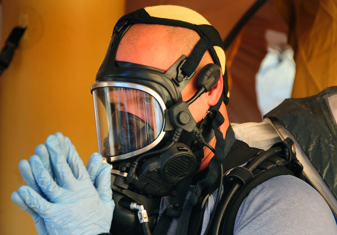 ELLSWORTH AIR FORCE BASE, S.D. - Air Force Staff Sgt. Danny Oaks, 82nd Civil Support Team survey team member, waits while his chemical protective suit is removed during a joint training mission with Ellsworth Air Force Base, the South Dakota National Guard and the Rapid City Fire Department in Rapid City, S.D., Nov 4.  During the joint training, Ellsworth Airmen assisted in clearing individuals from a simulated-contaminated bus stop. (U.S. Air Force photo/Senior Airman Anthony Sanchelli)
