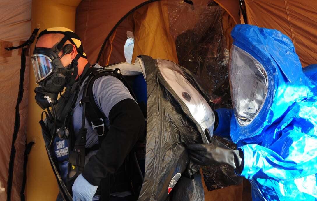 ELLSWORTH AIR FORCE BASE, S.D. -- (Left) Air Force Staff Sgt. Danny Oaks, 82nd Civil Support Team survey team member, gets help removing his chemical protective suit during a joint training mission in Rapid City, S.D., Nov 4.  The joint training included members from the Air Force, the South Dakota National Guard and the Rapid City Fire Department. (U.S. Air Force photo/Senior Airman Anthony Sanchelli)
