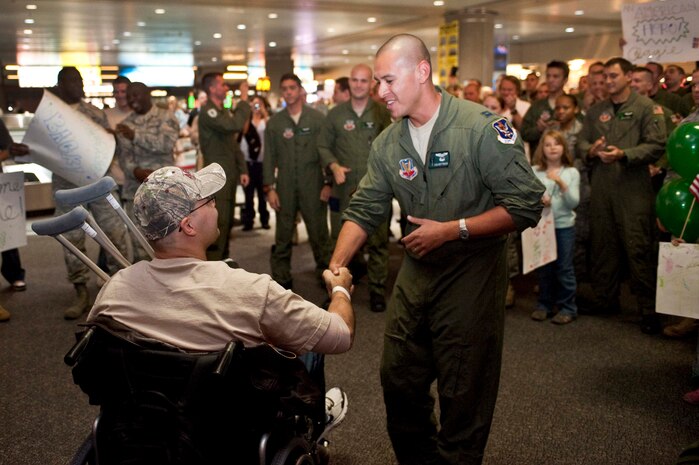 LAS VEGAS -- Master Sgt. Christopher Aguilera, an aerial gunner assigned to the 66th Rescue Squadron is welcomed home by Capt. Jacob Brittingham the 563 Rescue Group Det 1 flight commander, at McCarran International airport Nov. 4. Sergeant Aguilera returned to Las Vegas and Nellis Air Force Base, Nev., after spending the past four months at Brooke Army Medical Center in San Antonio, Texas recovering from injuries he received during an HH-60G Pave Hawk helicopter crash in southwest Afghanistan June 9, 2010 which killed five and left two Airmen in critical condition. (U.S. Air Force photo / Tech. Sgt. Michael R. Holzworth)(Released)



