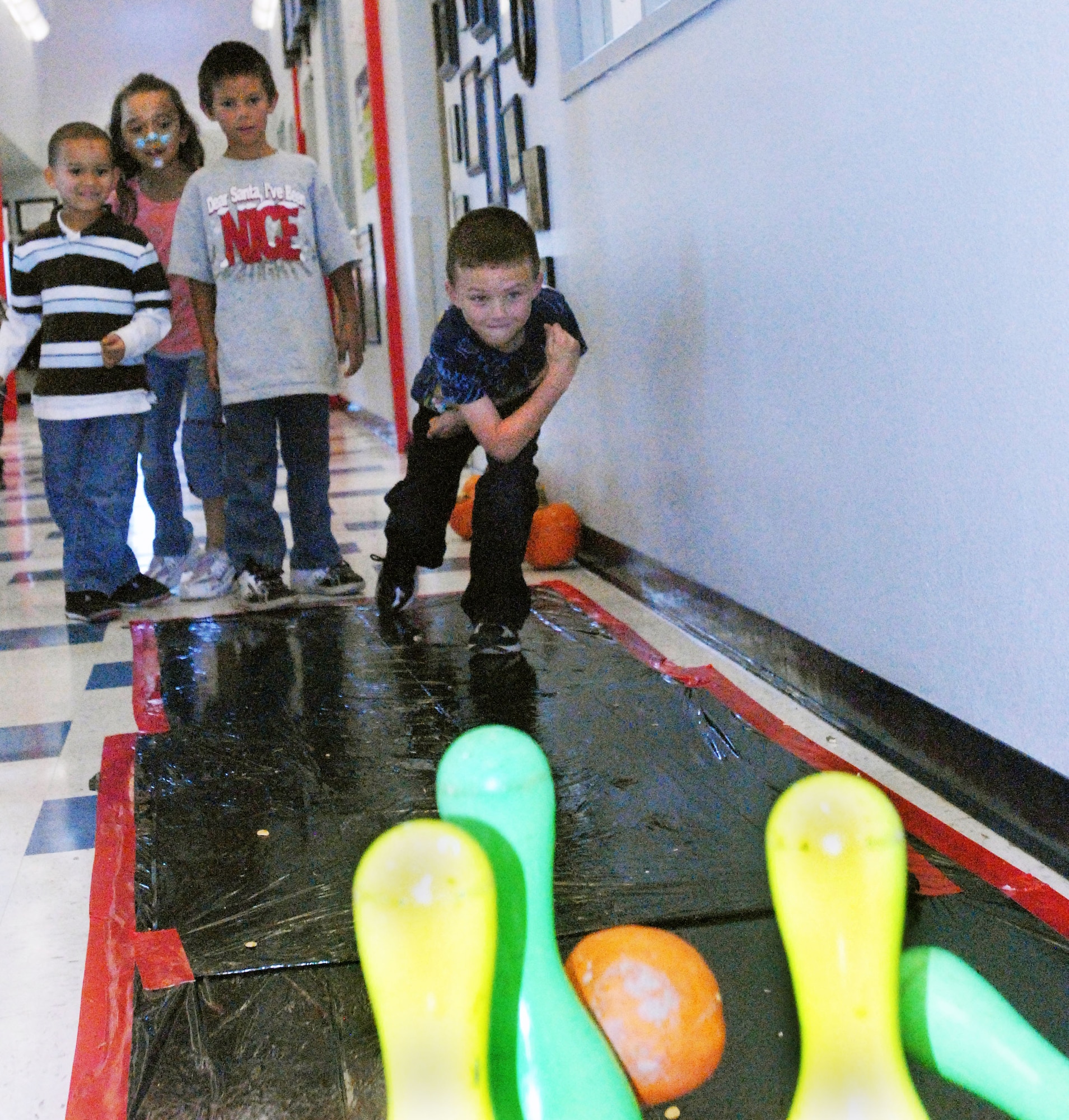 GOODFELLOW AIR FORCE BASE, Texas - Landen LaRue, 6, knocks a few pins down while bowling with a pumpkin during the Kids Fall Festival at the School Age Center Nov. 4. Military youths from the School Age and Youth Center organized and ran all the games held at this year's event. (U.S. Air Force photo/Connie Hempel)