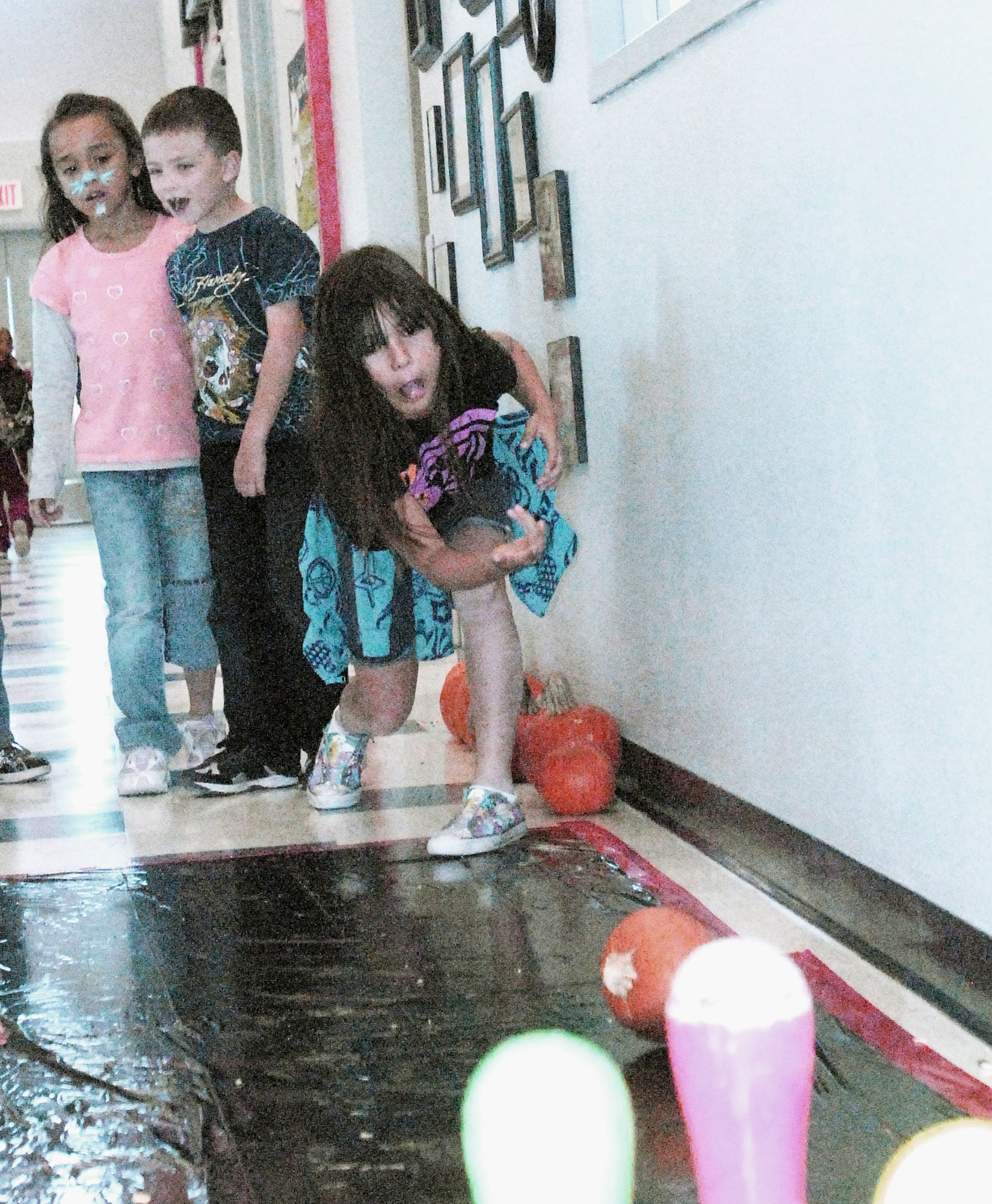 GOODFELLOW AIR FORCE BASE, Texas - Maylazia Vasquez, 7, bowls with a pumpkin during the Kids Fall Festival at the School Age Center Nov. 4. Military youths from the Youth Center and School Age organized and ran all the games held at this year's event. (U.S. Air Force photo/Connie Hempel)