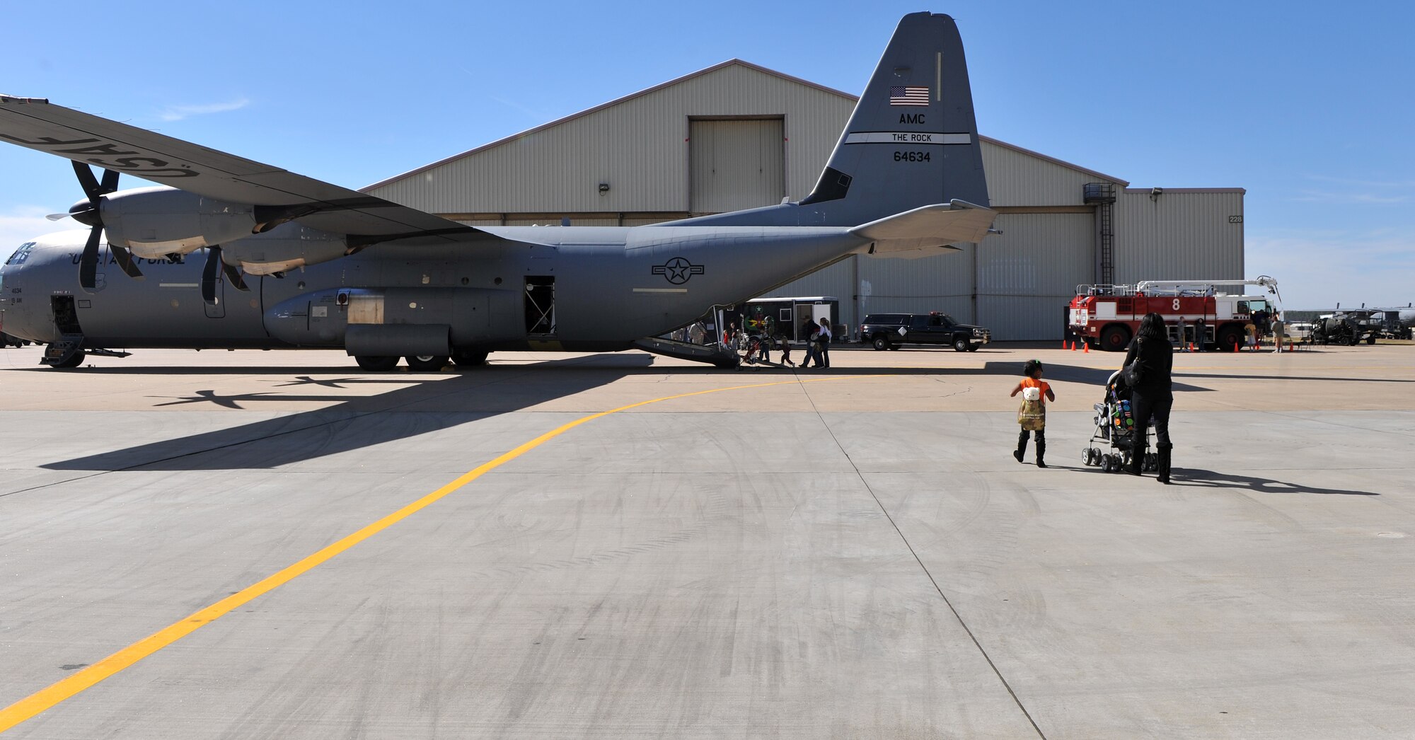 Families tour a C-130 Hercules during Operation Kids Understanding Deployment Operations Oct. 29. Operation K.U.D.O.S. is a program designed to give children the opportunity to experience what happens when their parents deploys. (U.S. Air Force photo by Senior Airman Gul Crockett)