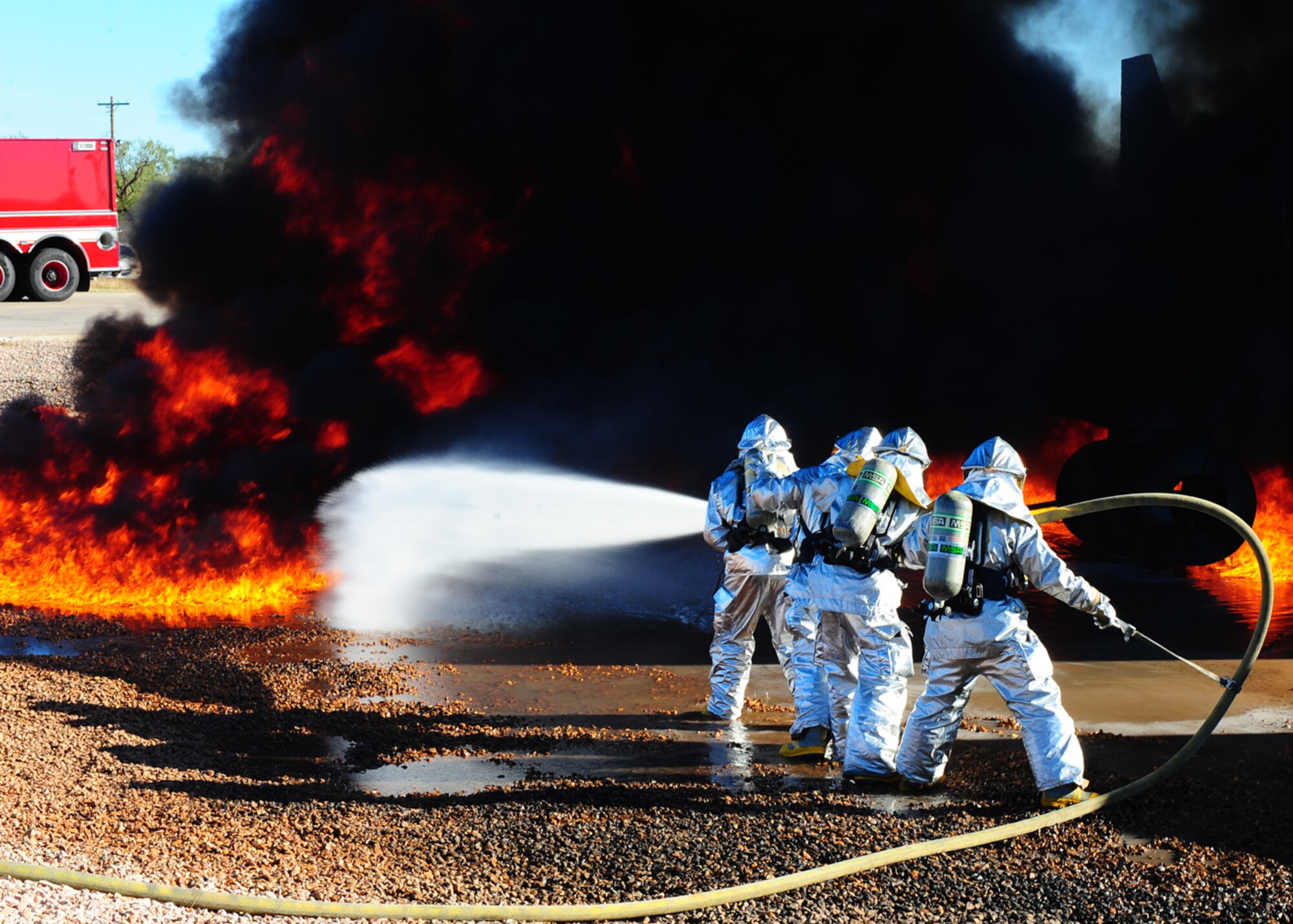 DYESS AIR FORCE BASE, Texas –Dyess and Abilene Regional airport (ABI) firefighters team up to extinguish an aircraft fire during a joint training exercise here Nov 5. Firefighters from ABI are required by the Federal Aviation Association (FAA) to be proficient in extinguishing aircraft fires. By inviting them onto the base, Dyess firefighters facilitate a means to achieve their annual training and foster a working  relationship.(U.S. Air Force Photo/Airman 1st Class Chelsea Cummings)