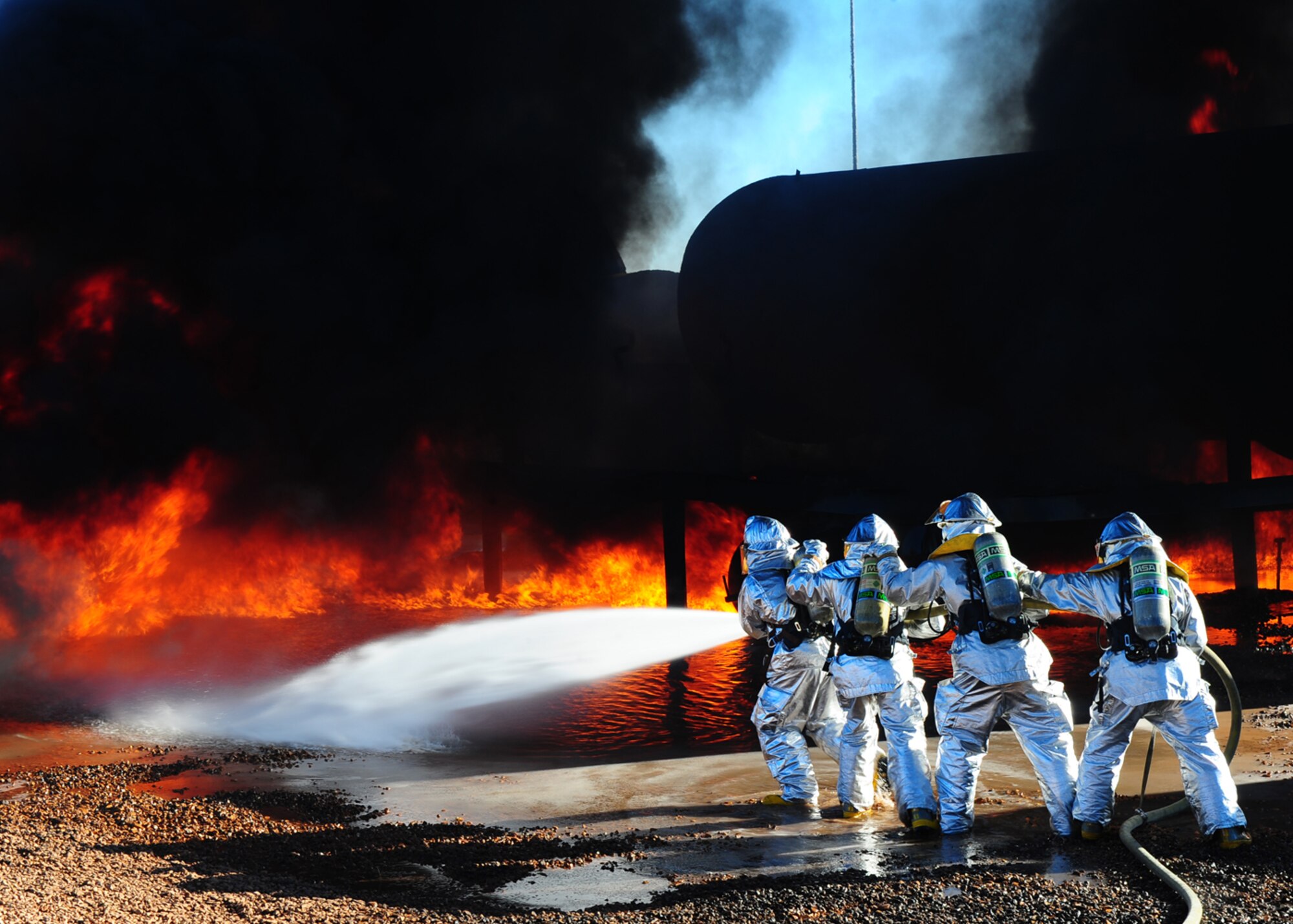 DYESS AIR FORCE BASE, Texas –Dyess and Abilene Regional airport (ABI) firefighters team up to extinguish an aircraft fire during a joint training exercise here Nov 5. Firefighters from ABI are required by the Federal Aviation Association (FAA) to be proficient in extinguishing aircraft fires. By inviting them onto the base, Dyess firefighters facilitate a means to achieve their annual training and foster a working  relationship.(U.S. Air Force Photo/Airman 1st Class Chelsea Cummings)