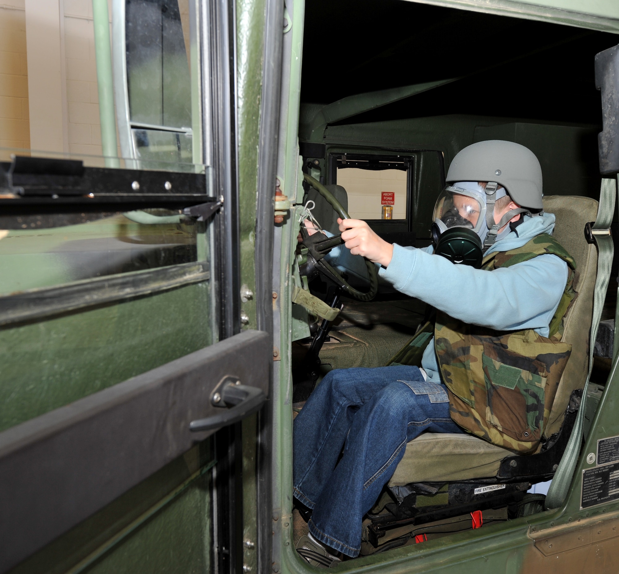 Marc Allerheiligen, son of Lt. Col. Nathan Allerheiligen, 50th Airlift Squadron commander, pretends to drive a Humvee during Operation Kids Understanding Deployment Operations Oct. 29. Operation K.U.D.O.S. is a program designed to give children the opportunity to experience what happens when their parents deploys. (U.S. Air Force photo by Senior Airman Gul Crockett)