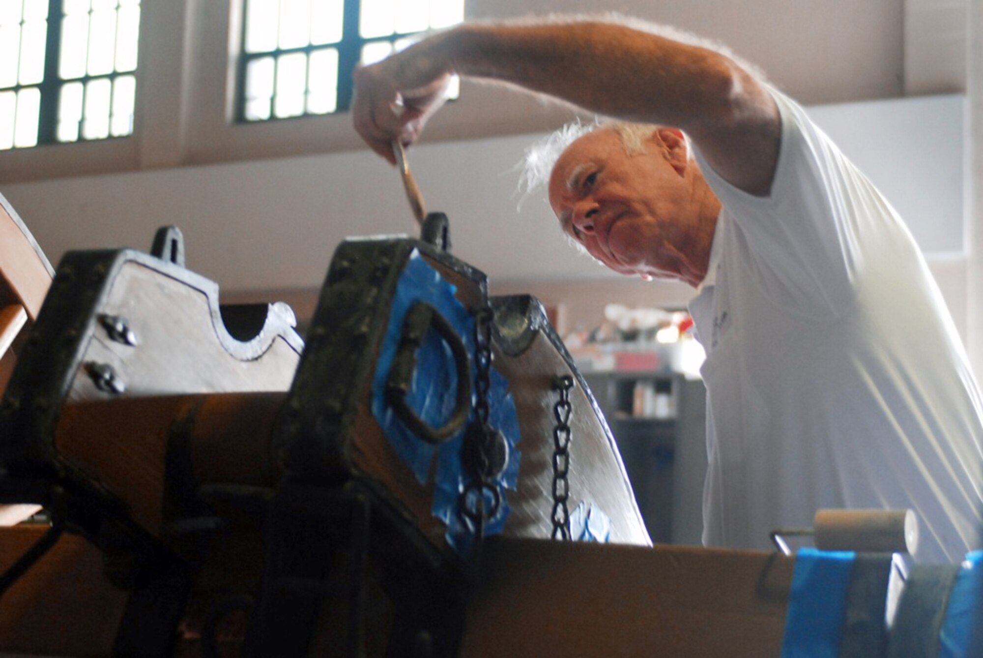 Retired Army Capt. Charles Monsted removes the rust from an 1860 Parrot Cannon Oct. 27, 2010, to be displayed in the Jackson Barracks Museum in New Orleans. The 122nd Bomb Squadron Restoration Unit is a group of volunteer retired Guardsmen who meet every Wednesday to help restore old military aircraft and cannons for the Jackson Barracks Museum. Captain Monsted is a member of the 122nd Bomb Squadron Restoration Unit. (U.S. Army photo/Spc. Jessica M. Lopez)