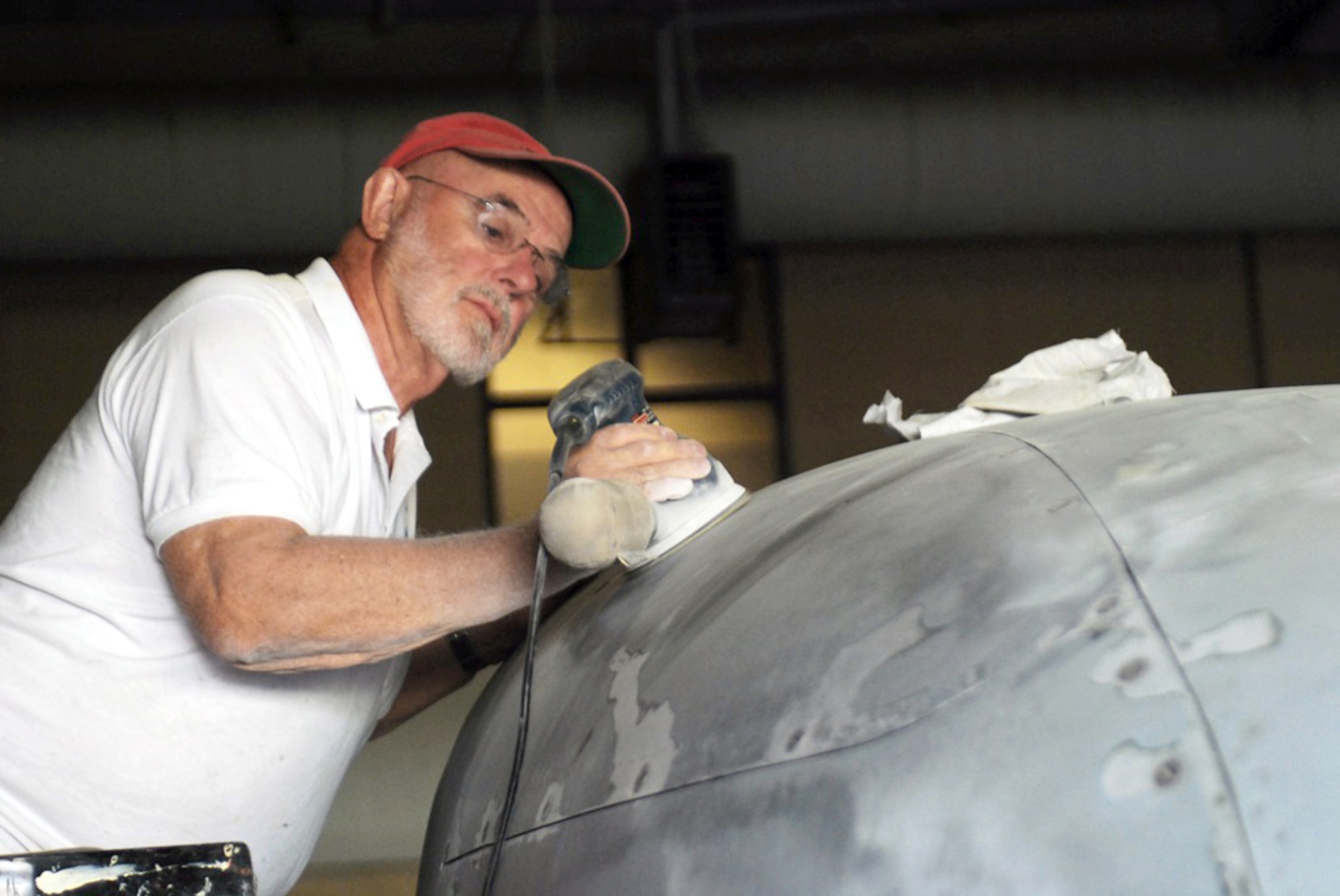Chapman Holbrook prepares the nose of a B-26 Marauder to be used as a monitor to display photos in the Jackson Barracks Museum Oct. 27, 2010, in New Orleans. The 122nd Bomb Squadron Restoration Unit is a group of volunteer retired Guardsmen who meet every Wednesday to help restore old military aircraft and cannons for the Jackson Barracks Museum. Mr. Holbrook is a member of the 122nd Bomb Squadron Restoration Unit. (U.S. Army photo/Spc. Jessica M. Lopez)
