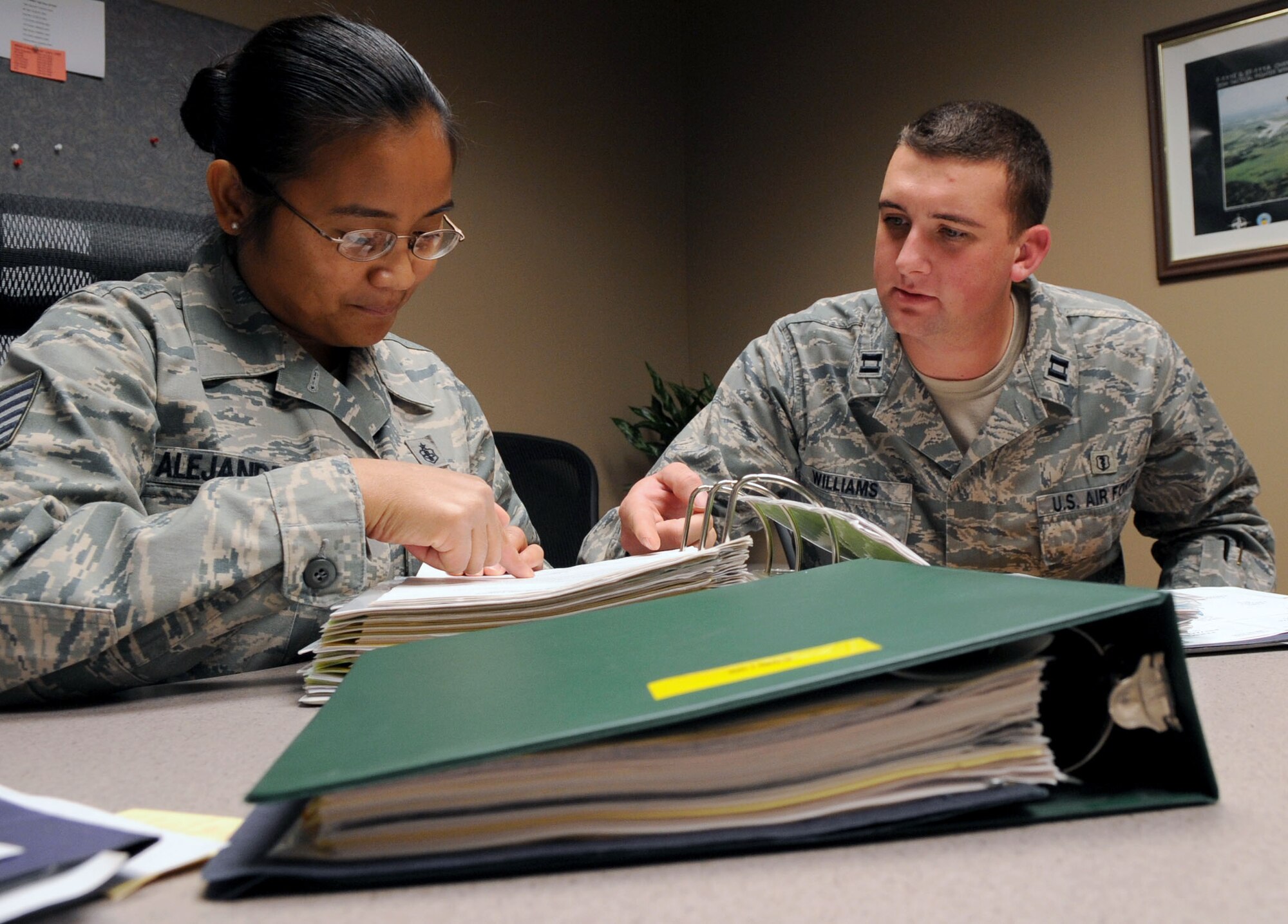 BARKSDALE AIR FORCE BASE, La ? Capt. James B. Williams, 2nd Medical Support Squadron officer in charge of pharmacy operations, and Tech. Sgt. Regie Alejandro, 2 MDSS NCO in charge of pharmacy operations, go over programs that will be inspected during the Health Services Inspection Nov. 3. The 2nd Medical Group will undergo their triennial HSI from Nov. 15 ? 19. (U.S. Air Force photo/Senior Airman La?Shanette V. Garrett)(RELEASED)