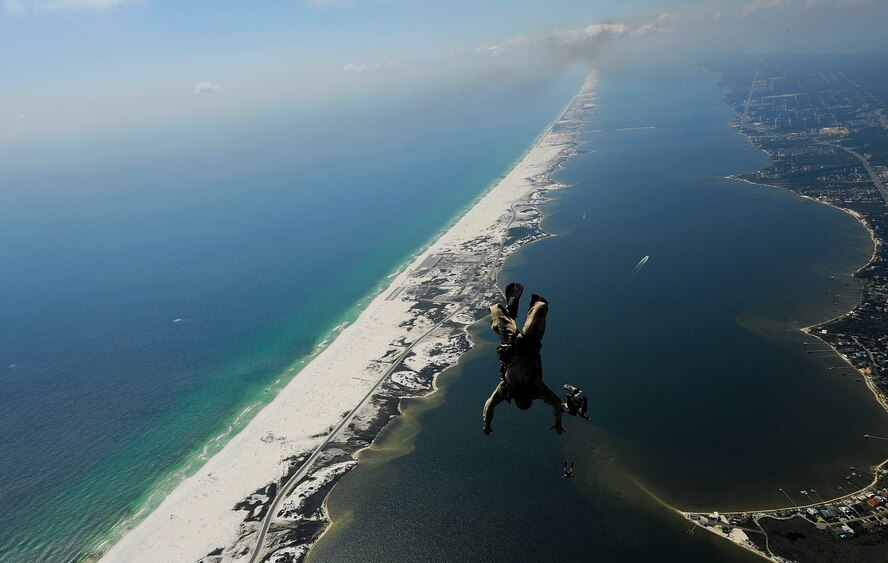 U.S. Air Force members from the 23rd Special Tactics Squadron, Air Force Special Operations Command, Hurlburt Field, Fla., jump out of the back of a C-130 Hercules Sept. 27, 2010. The airmen will practice combat operations in the Santa Rosa Sound. (U.S. Air Force Photo by Master Sgt. Russell E Cooley IV/Released)