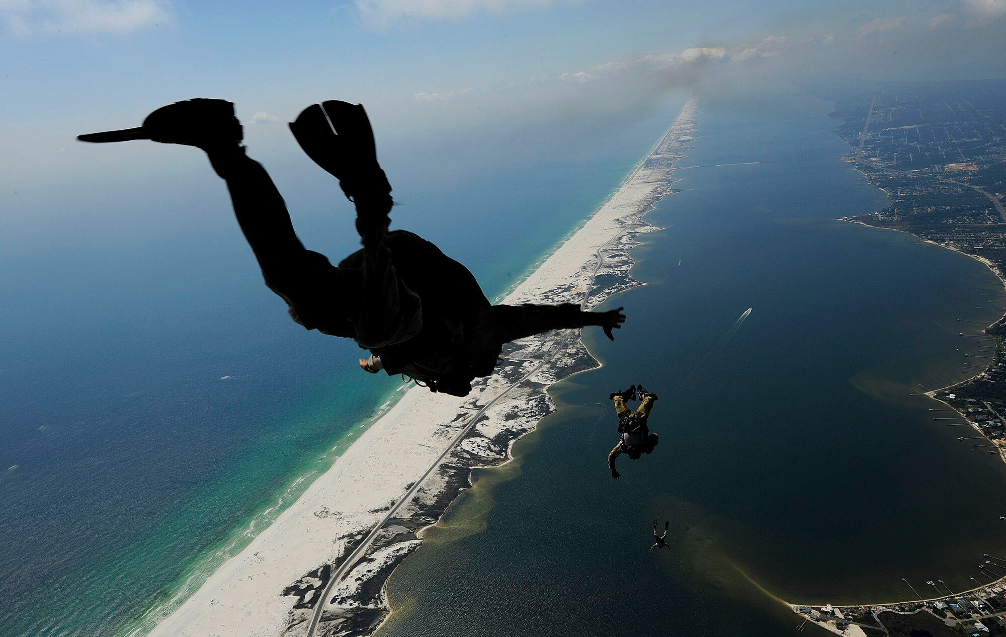 U.S. Air Force members from the 23rd Special Tactics Squadron, Air Force Special Operations Command, Hurlburt Field, Fla., jump out of the back of a C-130 Hercules Sept. 27, 2010. The airmen will practice combat operations in the Santa Rosa Sound. (U.S. Air Force Photo by Master Sgt. Russell E Cooley IV/Released)
