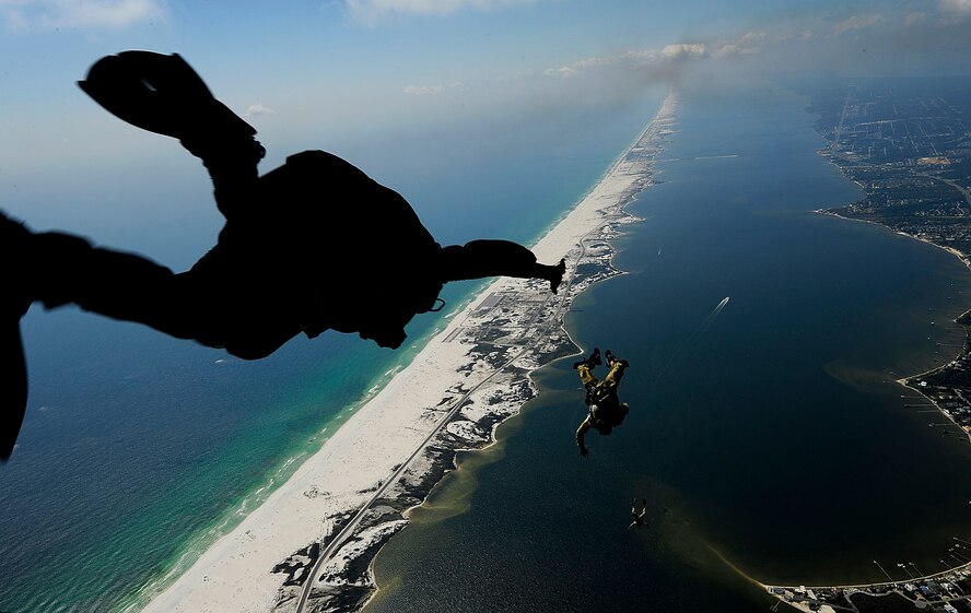 U.S. Air Force members from the 23rd Special Tactics Squadron, Air Force Special Operations Command, Hurlburt Field, Fla., jump out of the back of a C-130 Hercules Sept. 27, 2010. The airmen will practice combat operations in the Santa Rosa Sound. (U.S. Air Force Photo by Master Sgt. Russell E Cooley IV/Released)
