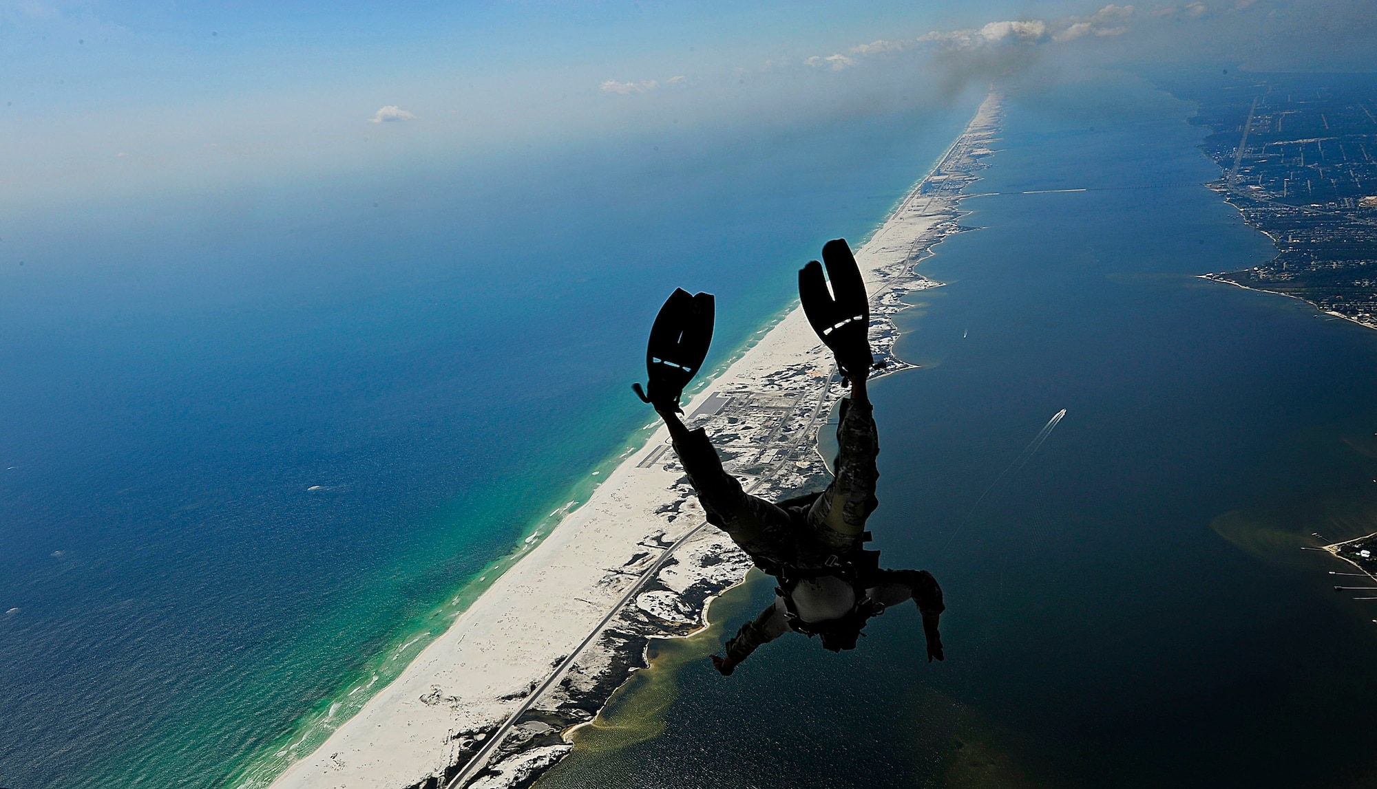 U.S. Air Force members from the 23rd Special Tactics Squadron, Air Force Special Operations Command, Hurlburt Field, Fla., jump out of the back of a C-130 Hercules Sept. 27, 2010. The airmen will practice combat operations in the Santa Rosa Sound. (U.S. Air Force Photo by Master Sgt. Russell E Cooley IV/Released)