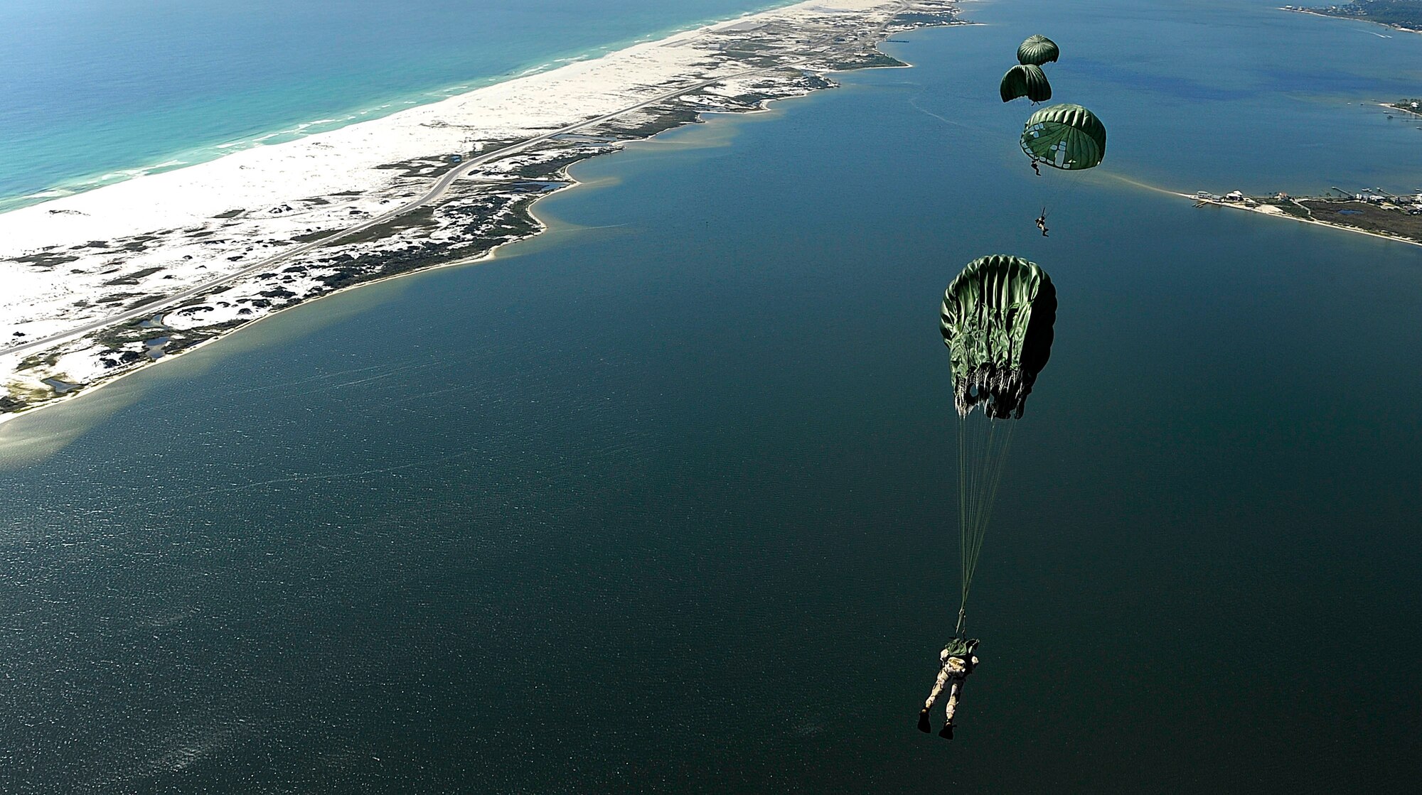 U.S. Air Force members from the 23rd Special Tactics Squadron, Air Force Special Operations Command, Hurlburt Field, Fla., jump out of the back of a C-130 Hercules Sept. 27, 2010. The airmen will practice combat operations in the Santa Rosa Sound. (U.S. Air Force Photo by Master Sgt. Russell E Cooley IV/Released)