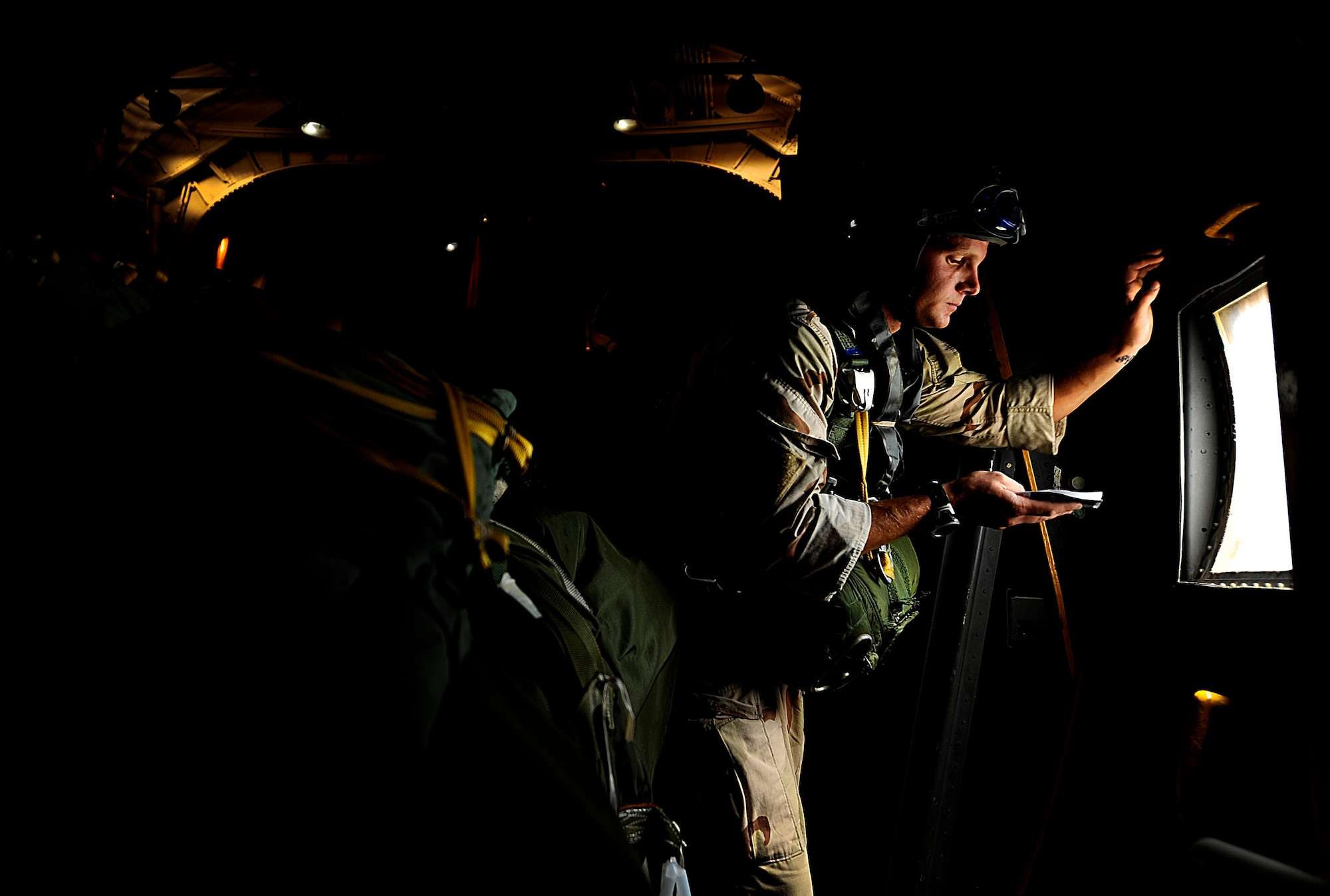 A U.S. Air Force jump master from the 23rd Special Tactics Squadron, Air Force Special Operations Command, Hurlburt Field, Fla., goes over final calculations  before his troops jump out of the back of a C-130 Hercules Sept. 27, 2010. The airmen will practice combat operations in the Santa Rosa Sound. (U.S. Air Force Photo by Master Sgt. Russell E Cooley IV/Released)
