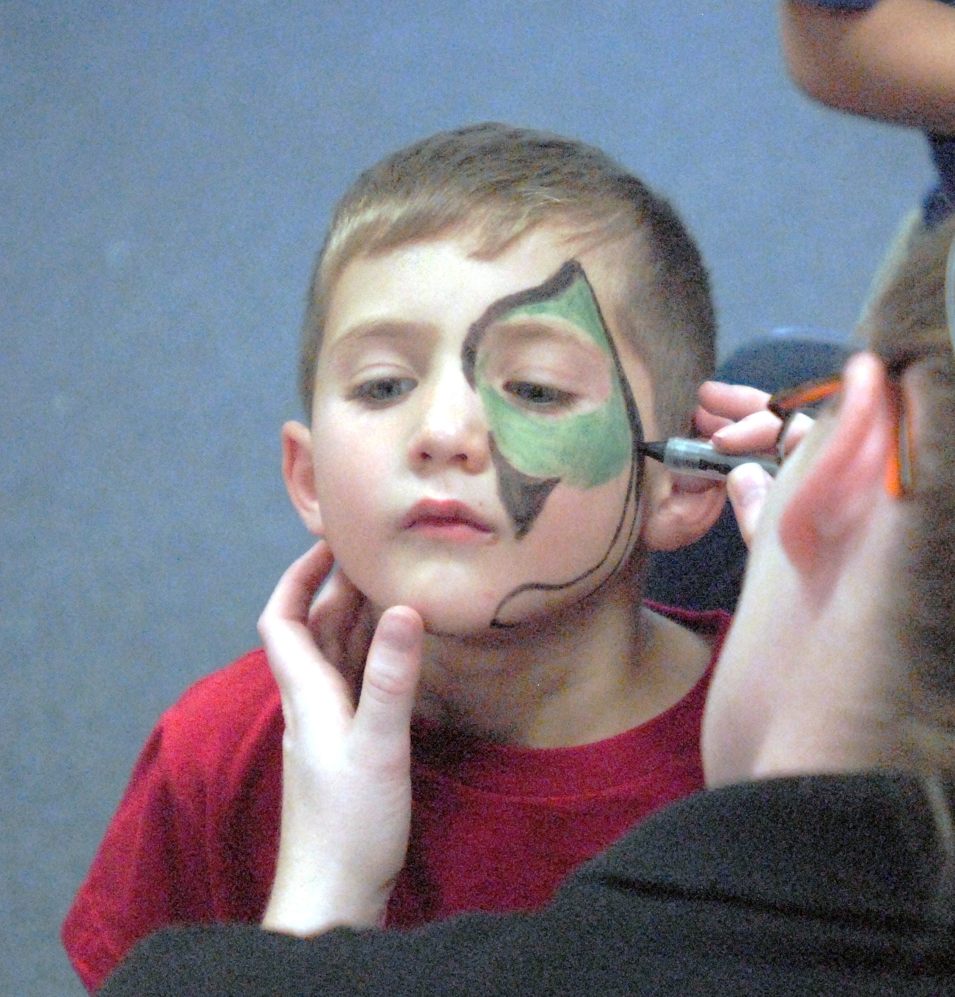 GOODFELLOW AIR FORCE BASE, Texas -- David Maldonado, 6, gets his face painted by Lauren Flood, School Age staff, during the Kids Fall Festival at the School Age Center Nov. 4.  Military youths from the Youth Center and School Age organized and ran all the games held at this year's event. (U.S. Air Force photo/Connie Hempel)