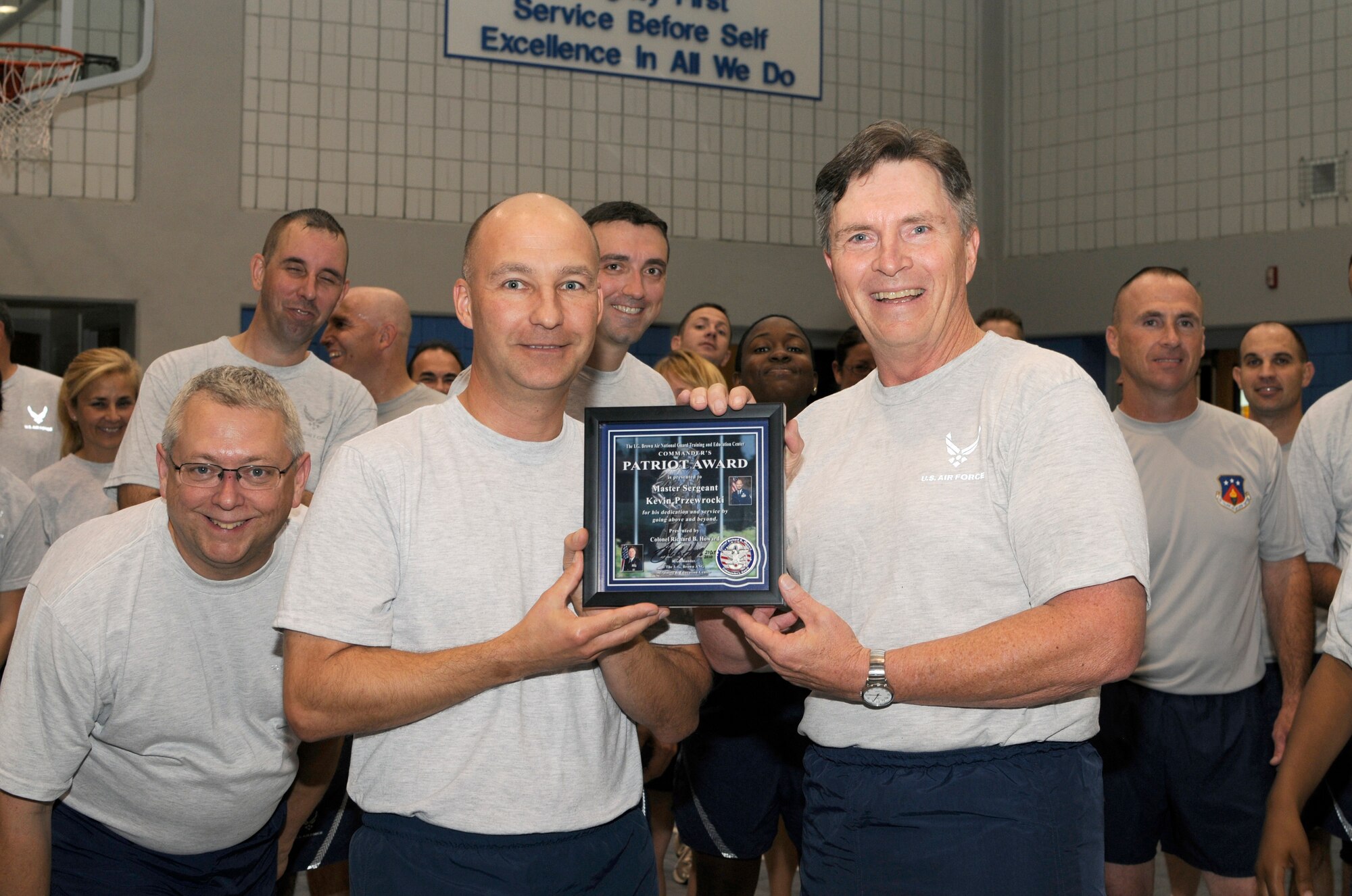 McGHEE TYSON AIR NATIONAL GUARD BASE, Tenn. - Colonel Richard B. Howard, right, commander of The I.G. Brown Air National Guard Training and Education Center, presents his Patriot Award to Master Sgt. Kevin J.Przewrocki, left, unit fitness coordinator, during the center's monthly fitness training session at Wilson Hall here, Oct. 27. The Patriot Award is Howard's personal award to show appreciation for those he feels have gone above and beyond in their service to the center.  (U.S. Air Force photo by Master Sgt. Kurt Skoglund/Released)