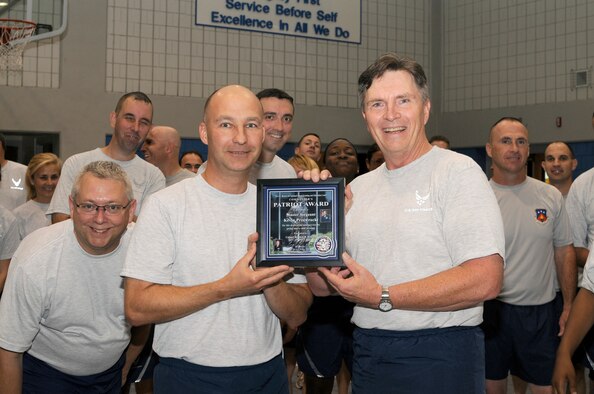 McGHEE TYSON AIR NATIONAL GUARD BASE, Tenn. - Colonel Richard B. Howard, right, commander of The I.G. Brown Air National Guard Training and Education Center, presents his Patriot Award to Master Sgt. Kevin J.Przewrocki, left, unit fitness coordinator, during the center's monthly fitness training session at Wilson Hall here, Oct. 27. The Patriot Award is Howard's personal award to show appreciation for those he feels have gone above and beyond in their service to the center.  (U.S. Air Force photo by Master Sgt. Kurt Skoglund/Released)