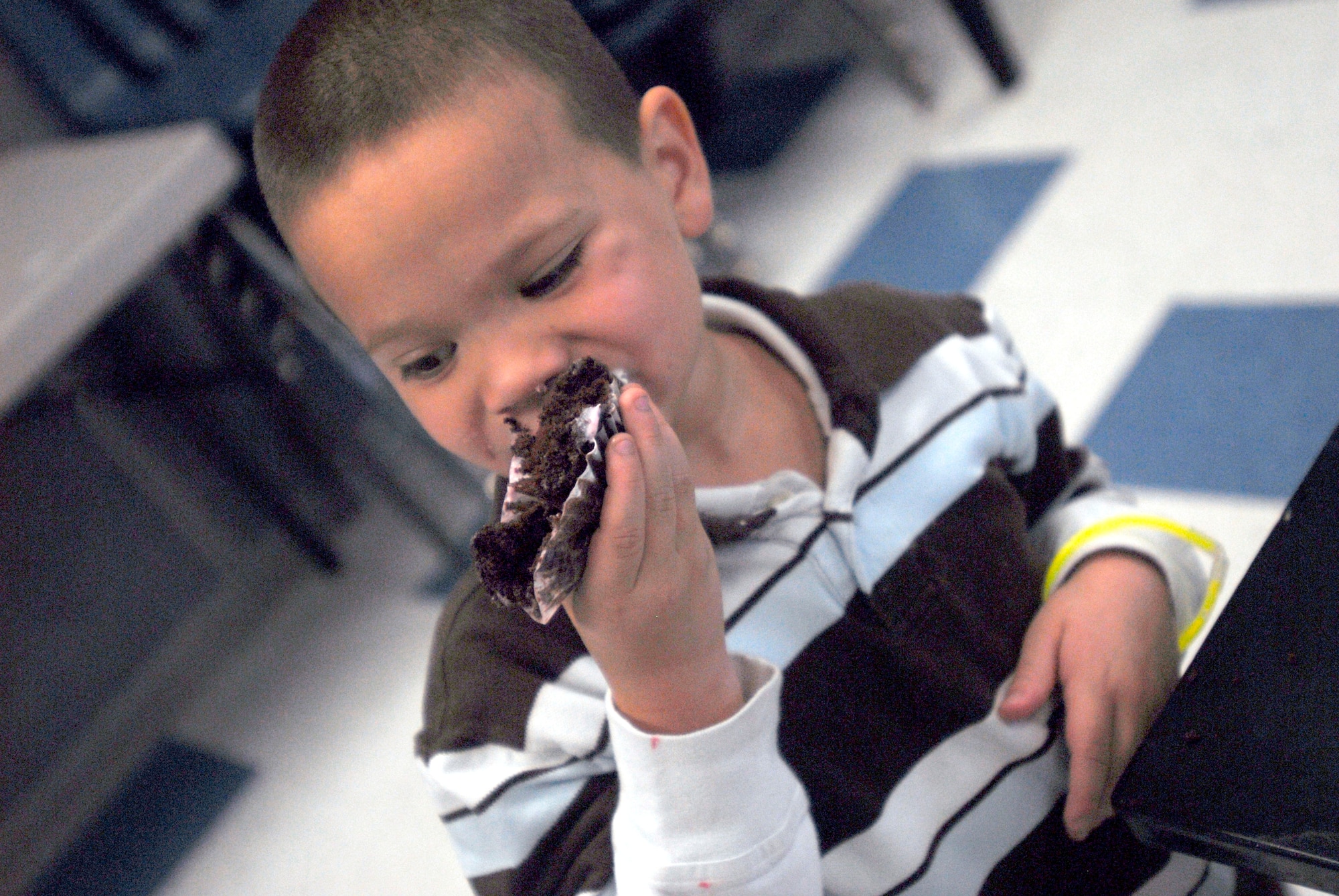 GOODFELLOW AIR FORCE BASE, Texas -- Christopher Marquez, 5, enjoys the cupcake he won from the cake walk game during the Kids Fall Festival at the School Age Center Nov. 4.  Military youths from the Youth Center and School Age organized and ran all the games held at this year's event. (U.S. Air Force photo/Connie Hempel)