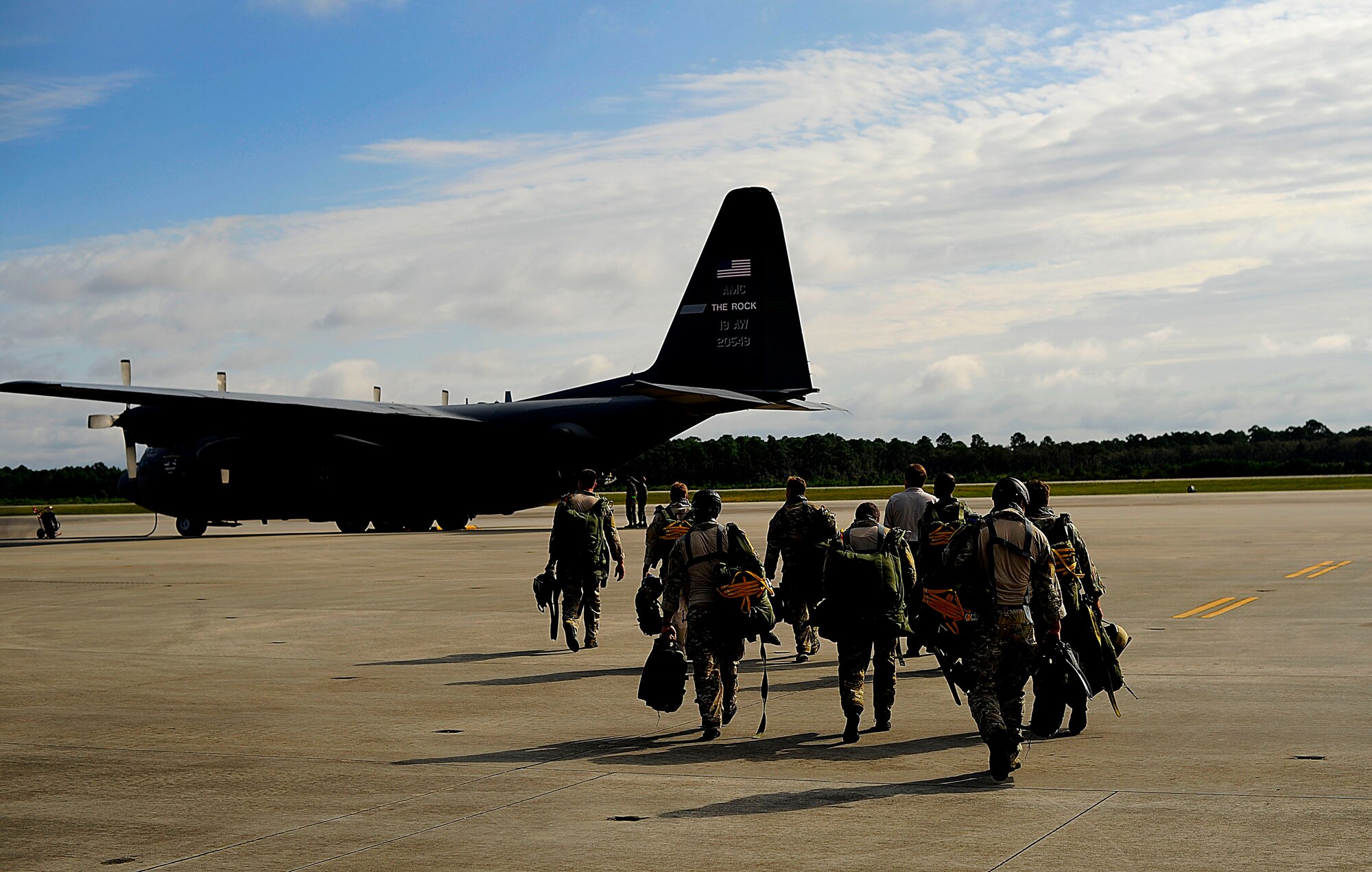 U.S. Air Force members from the 23rd Special Tactics Squadron, Air Force Special Operations Command, walk toward a C-130 Hercules at Hurlburt Field, Fla., Sept. 27, 2010. The airmen will practice combat operations in the Santa Rosa Sound. (U.S. Air Force Photo by Master Sgt. Russell E Cooley IV/Released)