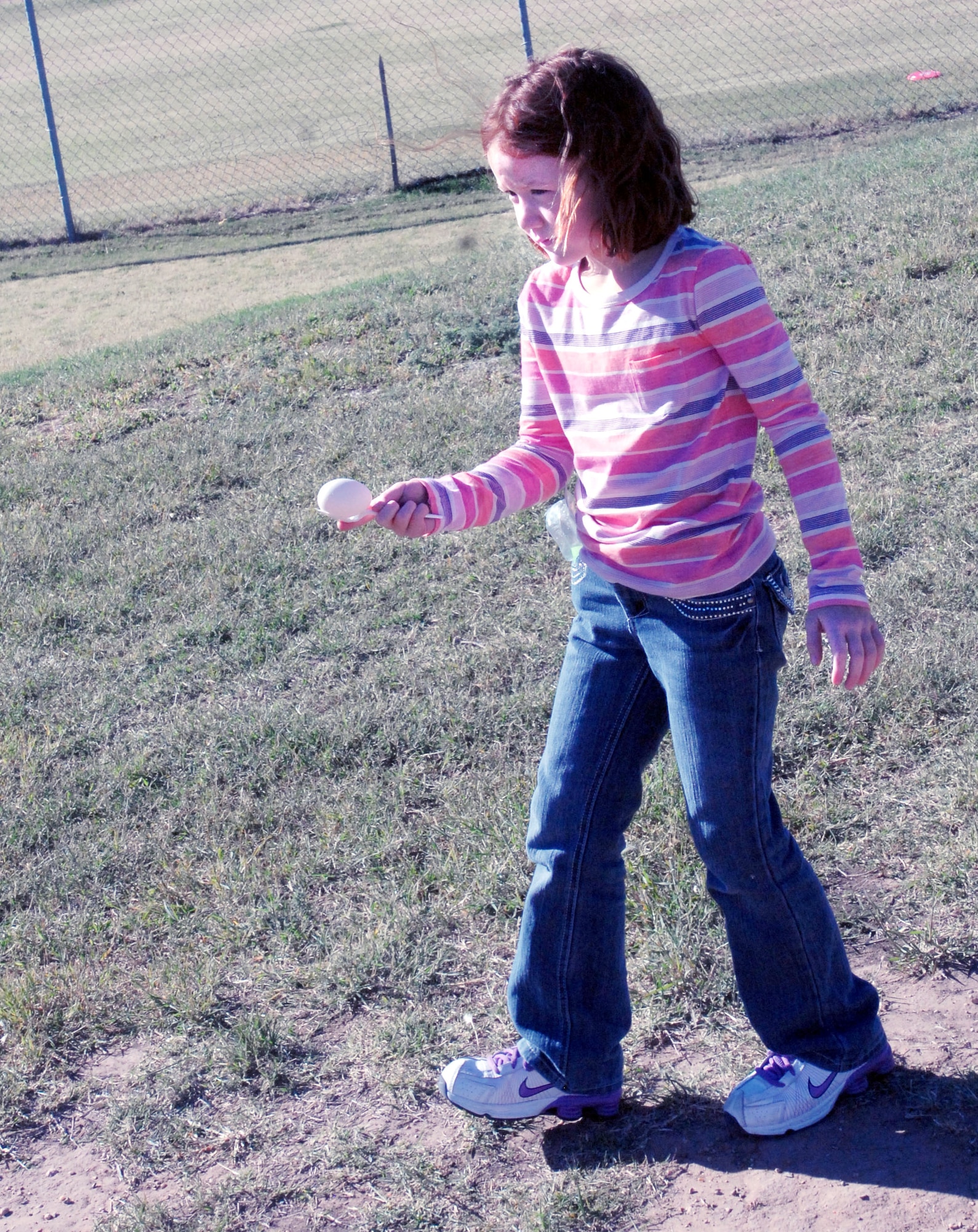 GOODFELLOW AIR FORCE BASE, Texas -- Skylar Baxley, 8, races to the finish line while balancing her egg on a spoon during the Kids Fall Festival at the School Age Center Nov. 4.  Military youths from the Youth Center and School Age organized and ran all the games held at this year's event. (U.S. Air Force photo/Connie Hempel)