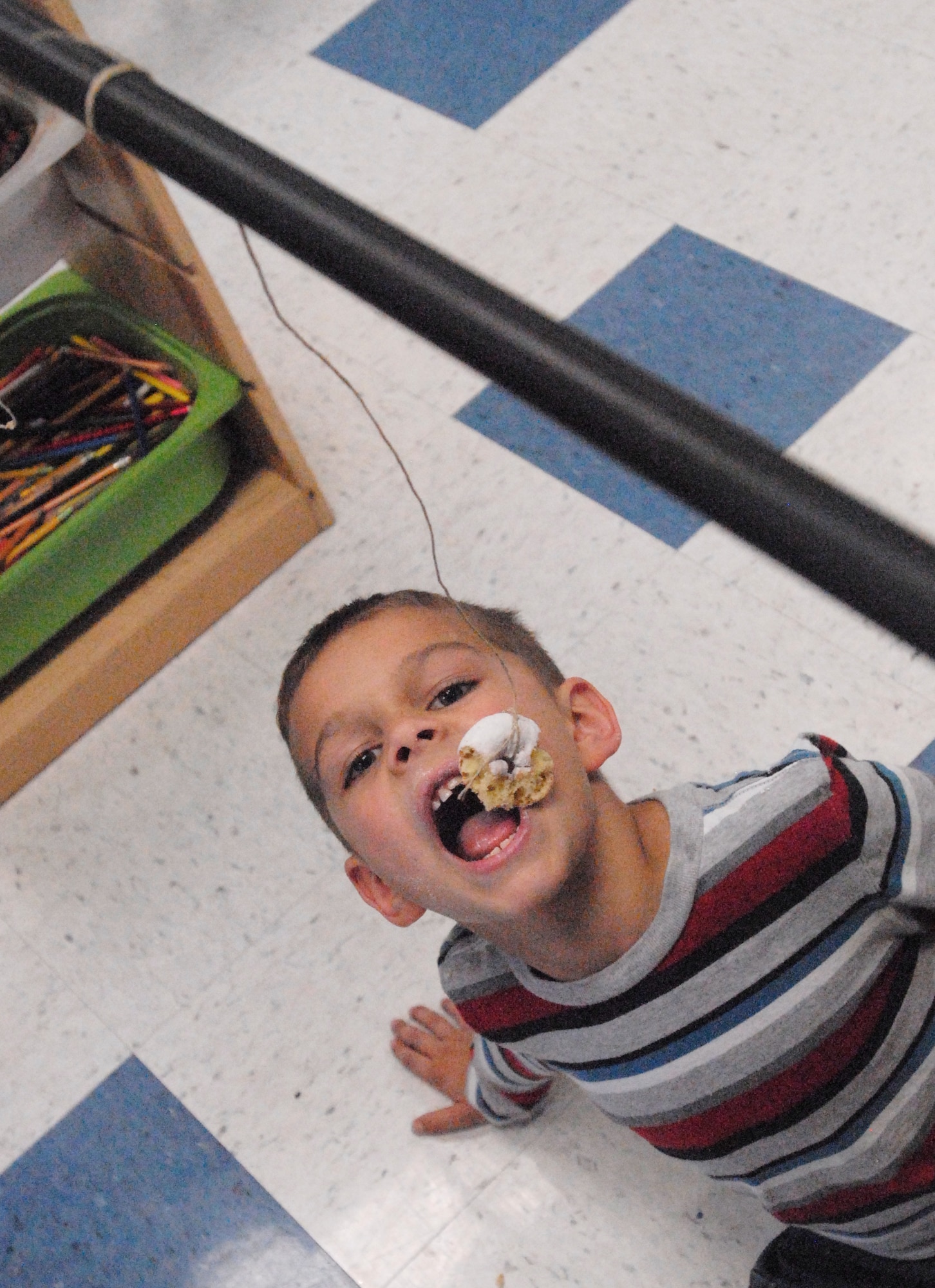 GOODFELLOW AIR FORCE BASE, Texas -- Noah Carter, 6, tries to eat a donut hanging on a string during the Kids Fall Festival at the School Age Center Nov. 4.  Military youths from the Youth Center and School Age organized and ran all the games held at this year's event. (U.S. Air Force photo/Connie Hempel)