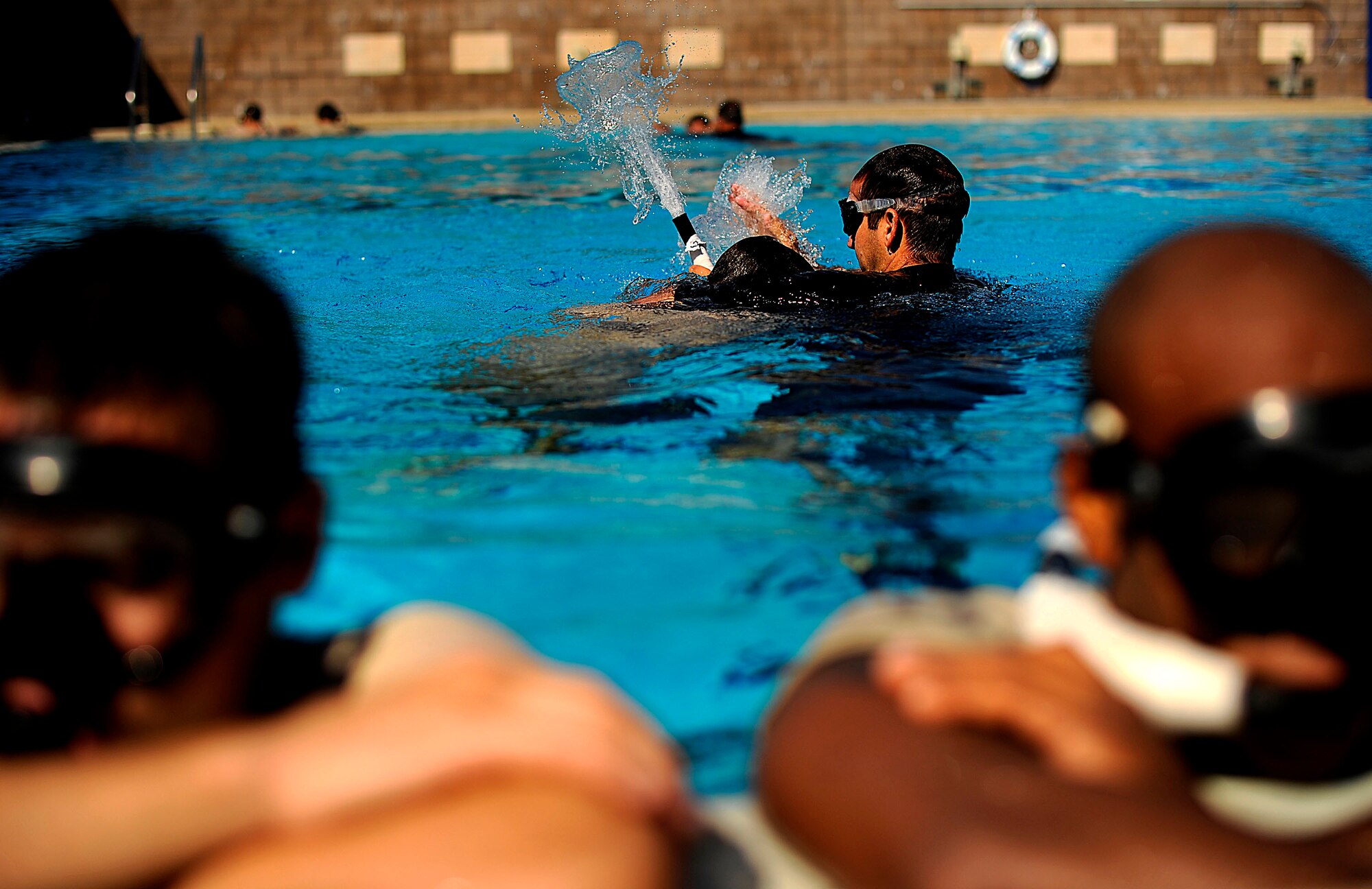 A U.S. Air Force Special Tactics Instructor from the Special Tactics Training Squadron, Air Force Special Operations Command, Hurlburt Field, Fla., tests students on buddy breathing during pre-scuba training Sept. 21, 2010. (U.S. Air Force Photo by Master Sgt. Russell E Cooley IV/Released)