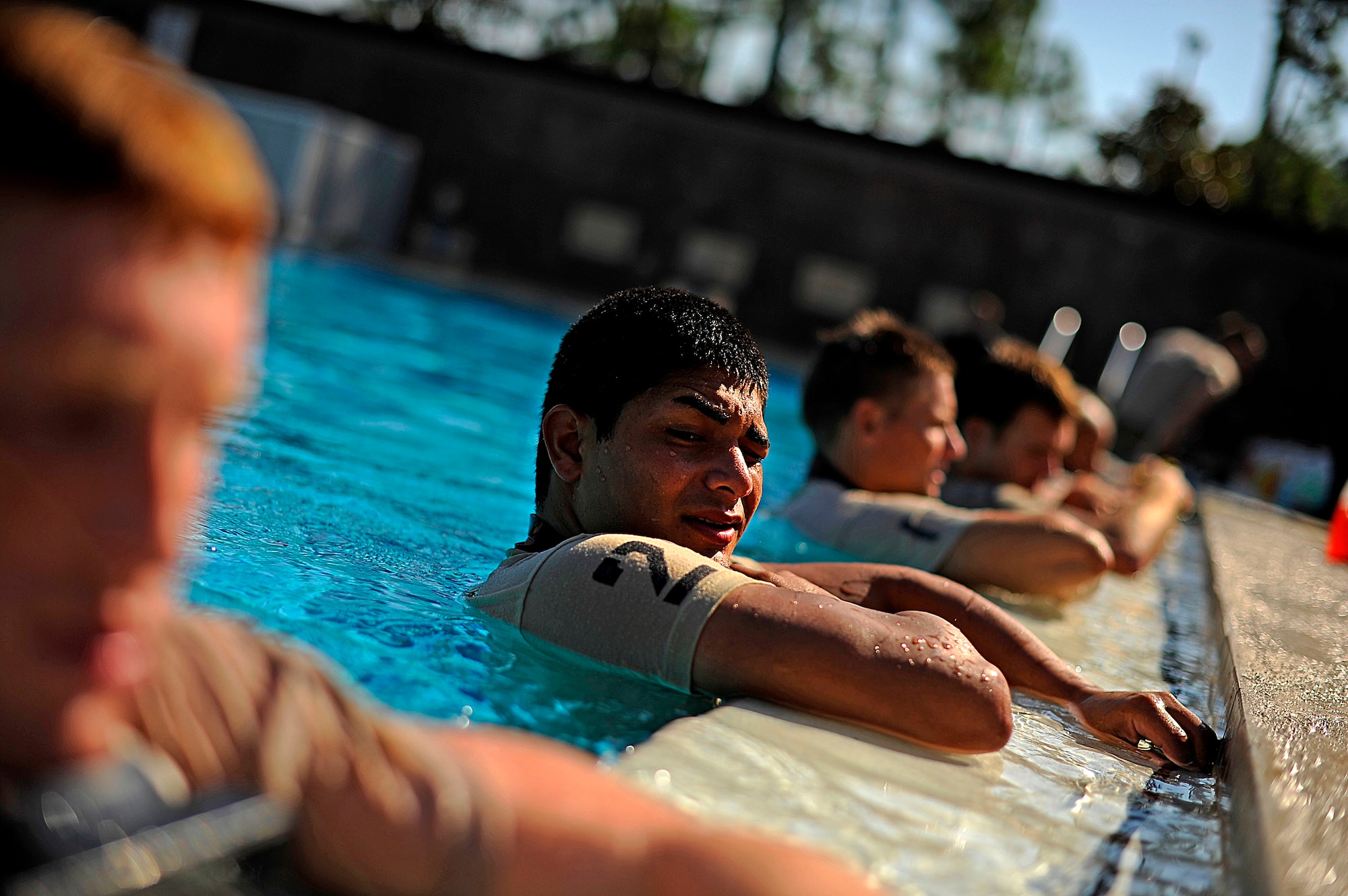 U.S. Air Force members from the Special Tactics Training Squadron, Air Force Special Operations Command, Hurlburt Field, Fla., rest on the side of the pool during pre-scuba training Sept. 21, 2010. (U.S. Air Force Photo by Master Sgt. Russell E Cooley IV/Released)