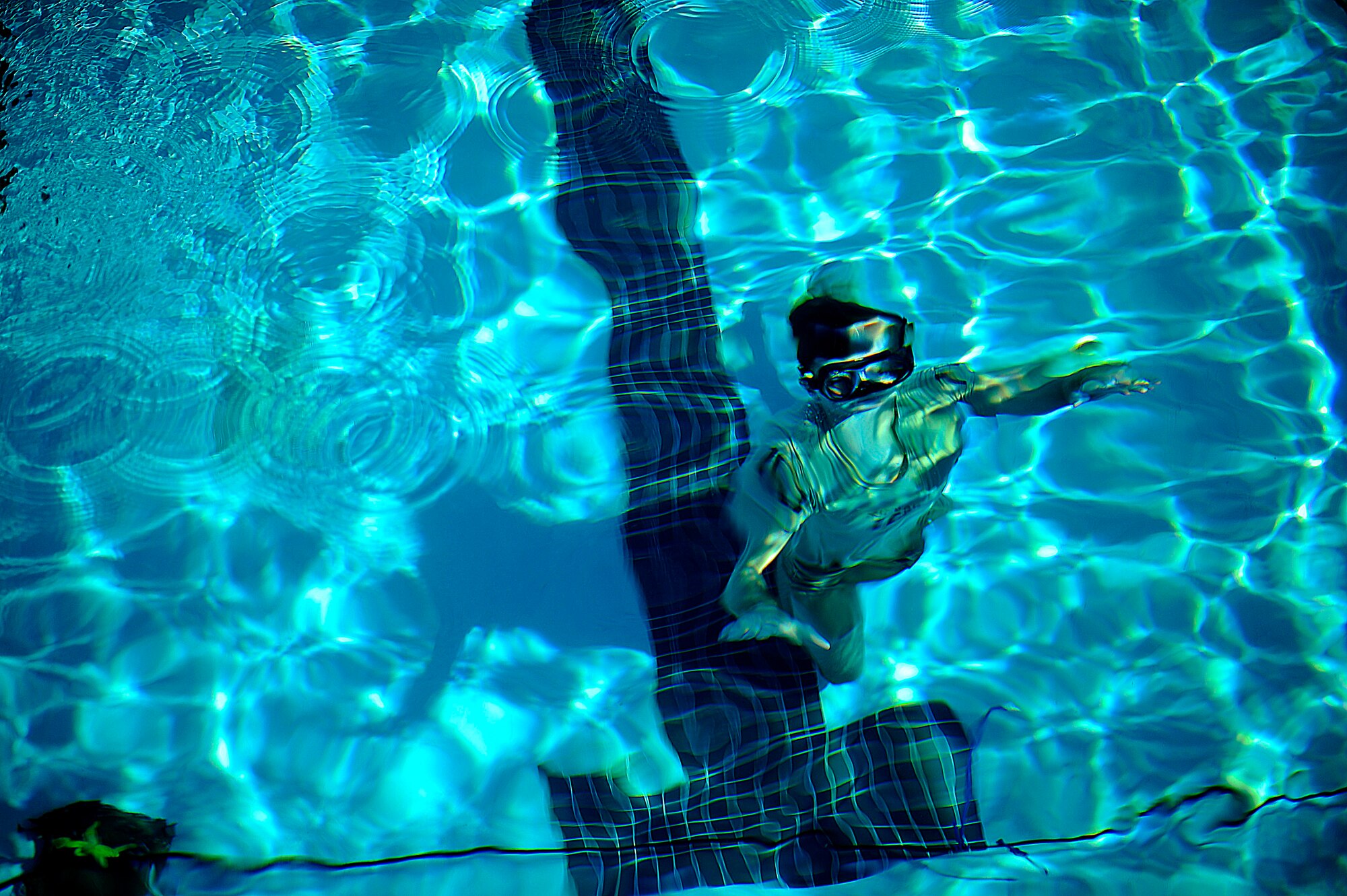 A U.S. Air Force member from the Special Tactics Training Squadron, Air Force Special Operations Command, Hurlburt Field, Fla., looks up from the bottom of the pool during pre-scuba training Sept. 21, 2010. (U.S. Air Force Photo by Master Sgt. Russell E Cooley IV/Released)