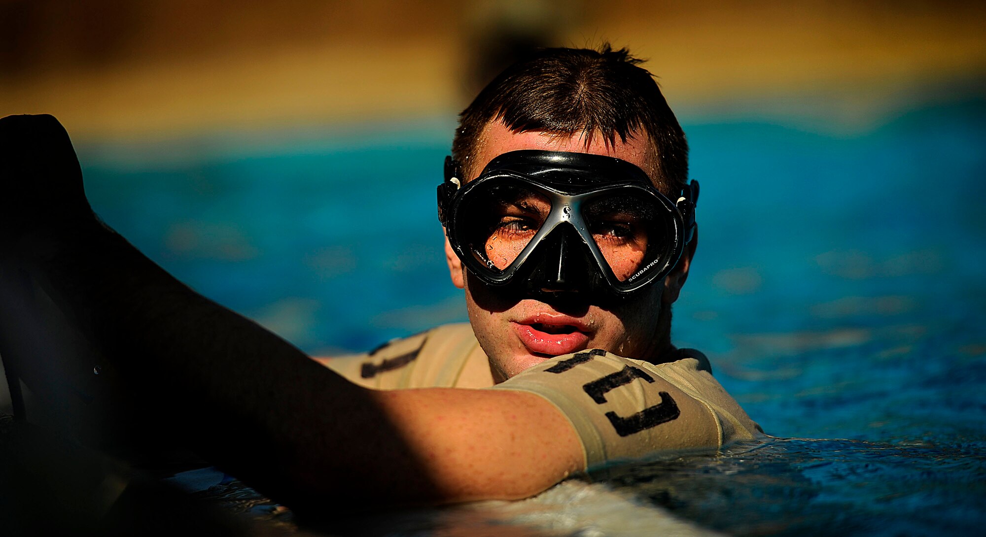 A U.S. Air Force member from the Special Tactics Training Squadron, Air Force Special Operations Command, Hurlburt Field, Fla., rests on the side of the pool during pre-scuba training Sept. 21, 2010. (U.S. Air Force Photo by Master Sgt. Russell E Cooley IV/Released)