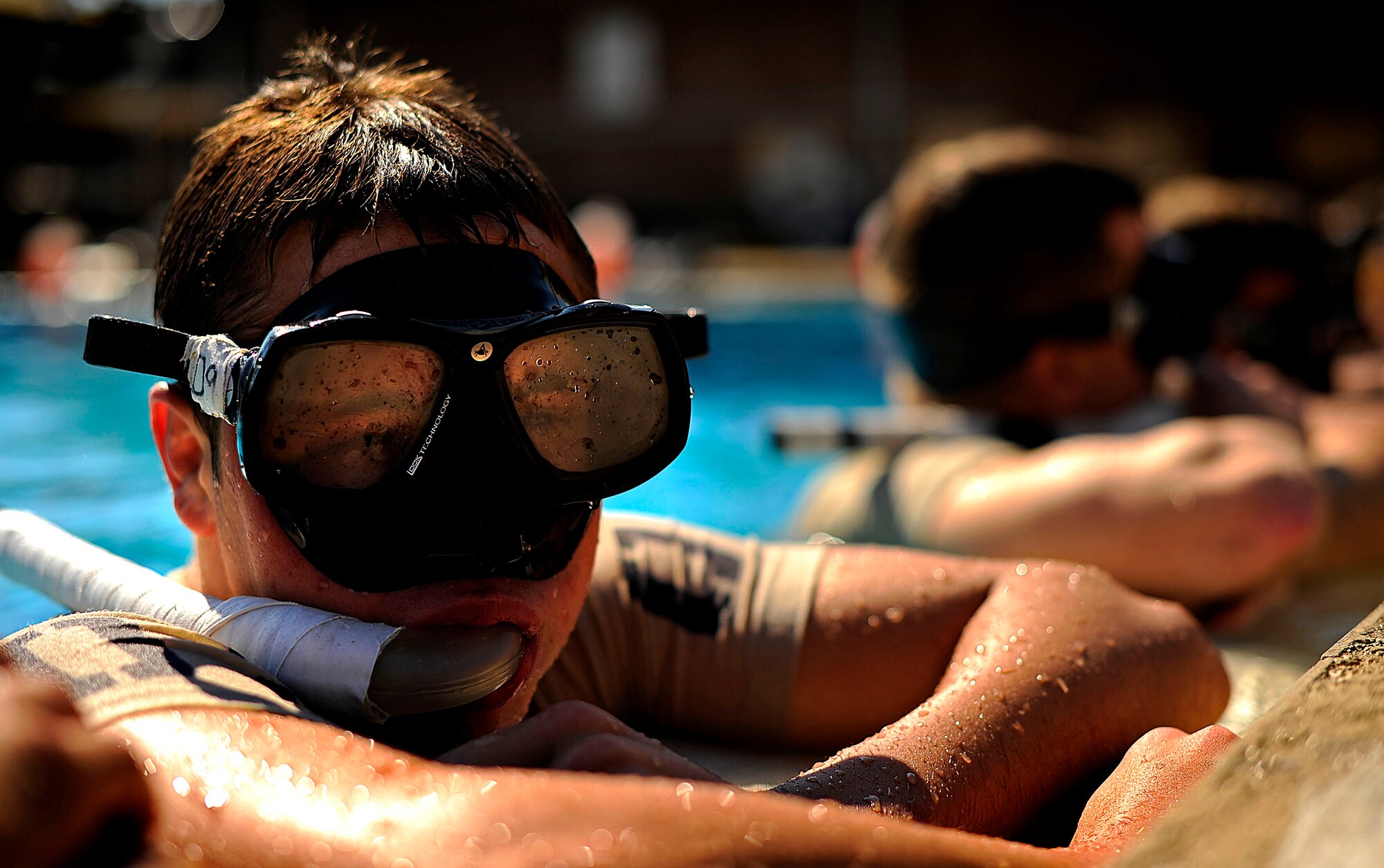 A U.S. Air Force member from the Special Tactics Training Squadron, Air Force Special Operations Command, Hurlburt Field, Fla., rests on the side of the pool during pre-scuba training Sept. 21, 2010. (U.S. Air Force Photo by Master Sgt. Russell E Cooley IV/Released)