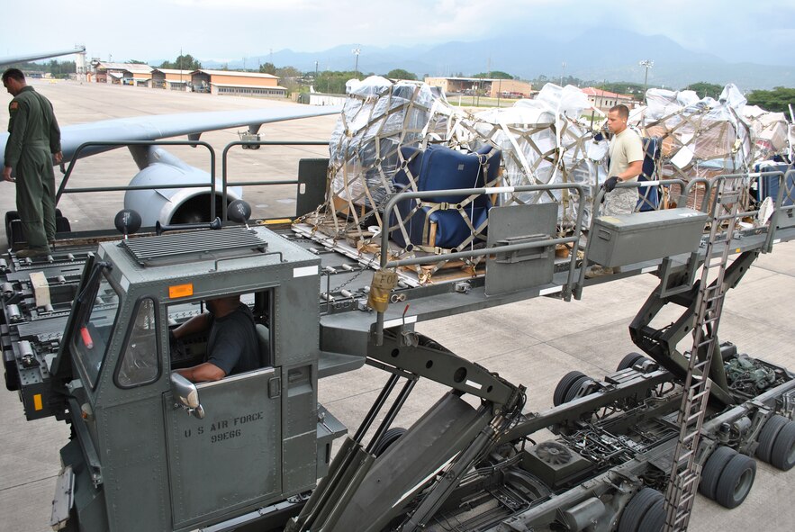 Aircrew members from the 2nd Air Refueling Squadron out of Joint Base McGuire-Dix-Lakehurst, N.J., and Airmen from the 612th Air Base Squadron Air Terminal Operations Center work together to unload eight pallets of humanitarian supplies at Soto Cano Air Base, Honduras, on Oct. 25, 2010. The supplies were brought here through the Denton Program, which allows the Department of Defense to use extra space on U.S. military cargo aircraft to transport humanitarian assistance materials. (U.S. Air Force Photo/Staff Sgt. Andre De La Torre) 