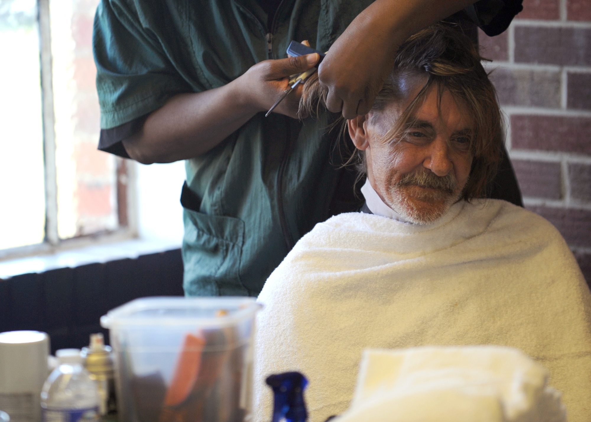 Tony Skinner gets his hair trimmed by a volunteer barber at the 11th annual Stand Down Against Homelessness Oct. 29, 2010, at North Charleston Armory Park, S.C. More than 2,068 homeless veterans and civilians received services like haircuts to help get them back on their feet and raise morale in the process. Mr. Skinner is an Army veteran. (U.S. Air Force photo/Senior Airman Timothy Taylor) 