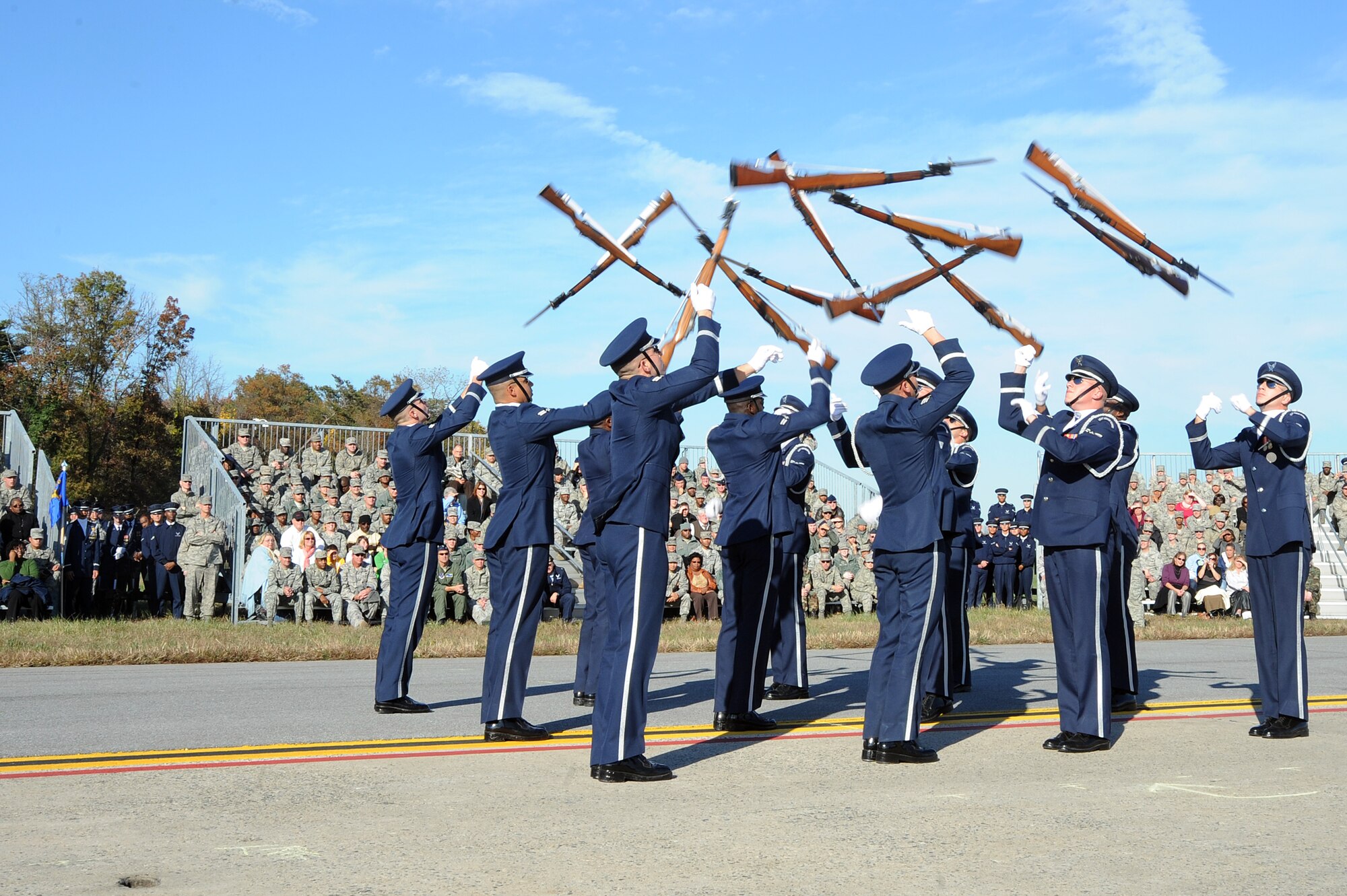 Members of the U.S. Air Force Honor Guard drill team perform a maneuver during the 11th Wing commander's call Nov. 2, 2010, at the Joint Base Andrews, Md. The commander's call highlighted the unique assets of the 11th WG through demonstrations by the 1st Helicopter Squadron, the Air Force Honor Guard and the Air Force Band. (U.S. Air Force photo/Senior Airman Melissa Brownstein)