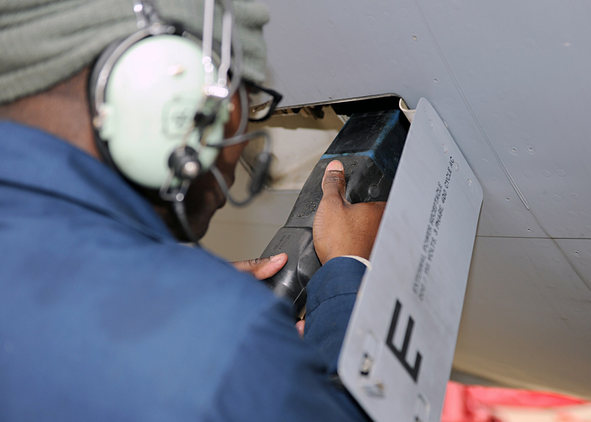 RAF MILDENHALL, England -- Senior Airman Nicholas Heyward, 100th Aircraft Maintenance Squadron crew chief, attaches an electrical power cart to a KC-135 Strotanker during a pre-flight inspection here Nov. 1, 2010.  This machine provides electricity so checks can be done before the aircraft is started.  (U.S. Air Force photo/Senior Airman Tabitha M. Lee)  