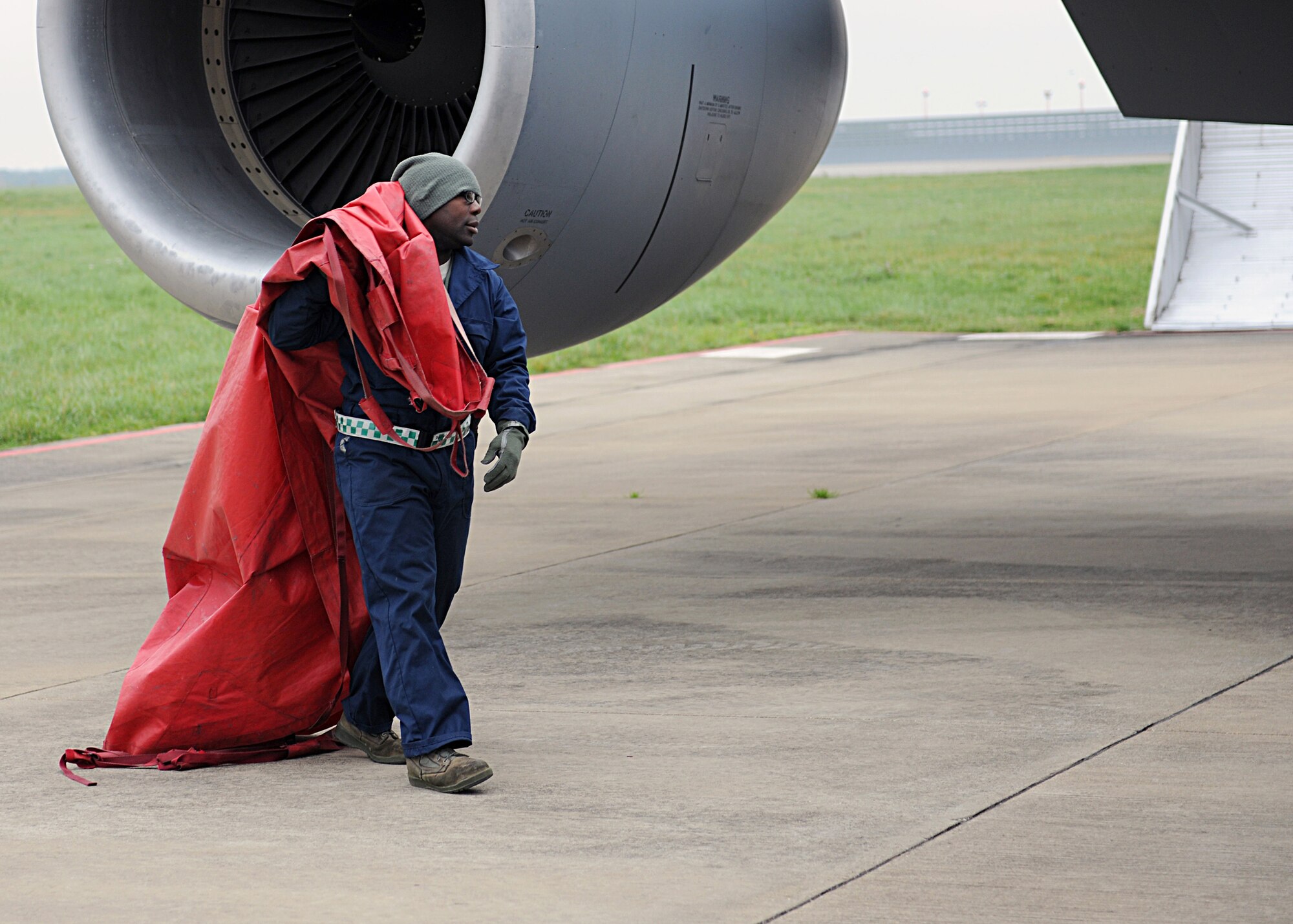 RAF MILDENHALL, England -- Senior Airman Nicholas Heyward, 100th Aircraft Maintenance Squadron crew chief, moves an engine inlet cover during a pre-flight inspection here Nov. 1, 2010.  This aircraft was one of a three-ship formation that refueled a B-52 Stratofortress.  (U.S. Air Force photo/Senior Airman Tabitha M. Lee)  