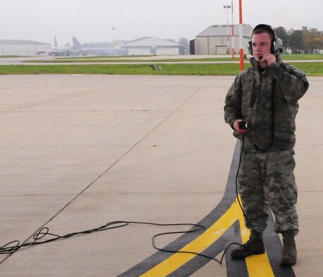 RAF MILDENHALL, England -- Senior Airman Scott Kenady, 100th Aircraft Maintenance Squadron crew chief, tests out communications systems with the aircrew on board a  KC-135 Stratotanker, which was part of the three-ship refueling mission with a B-52 Stratofortress Nov. 1, 2010. Each of the three aircraft off-loaded about 70,000 pounds of JP-8 aviation fuel. (U.S. Air Force photo/Karen Abeyasekere)