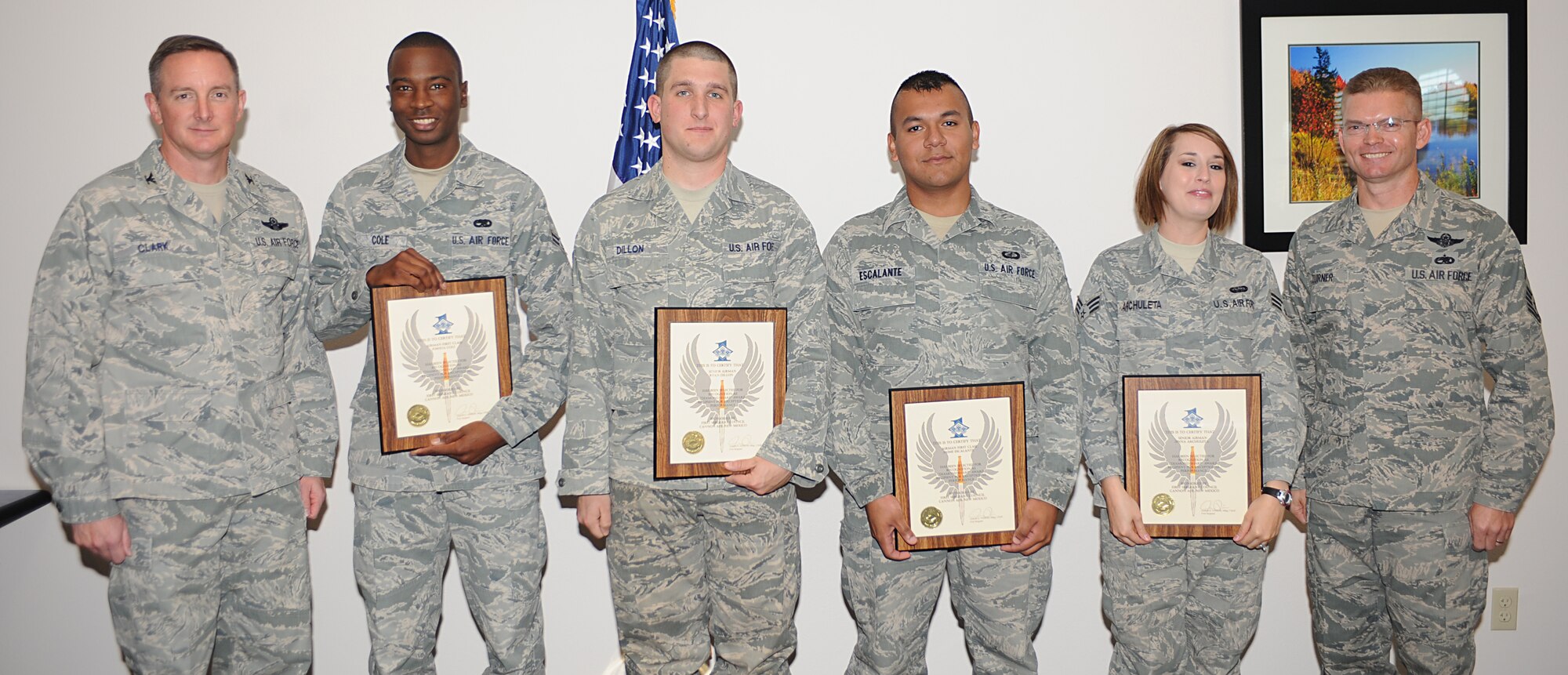 Diamond Sharp award winners, Airman 1st Class Joshua Cole, 27th Special Operations Equipment Maintenance Squadron, Senior Airman Ryan Dillon, 27th Special Operations Aircraft Maintenance Squadron, Airman 1st Class Jaime Escalante, 27th Special Operations Comptroller Squadron and Senior Airman Jenna Archuleta, 27th Special Operations Communications Squadron, stand with Col. Stephen Clark (left), 27th Special Operations Wing commander, and  Chief Master Sgt. William Turner (right), 27 SOW command chief, following the monthly Diamond Sharp breakfast at The Landing Zone at Cannon Air Force Base, N.M., Nov. 5, 2010. Diamond Sharp Airmen are selected monthly by Cannon's first sergeants to recognize Airmen who exemplify Air Force standards of conduct and performance. (U.S. Air Force photo by Senior Airman Maynelinne De La Cruz)