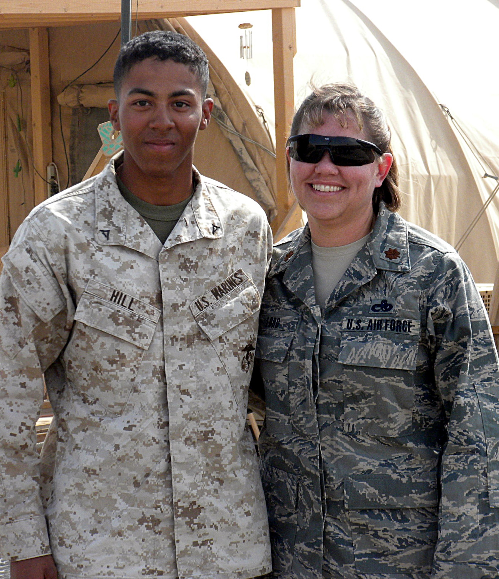 U.S. Marine Lance Cpl. James Hill stands beside his mother, Maj. Cindy Lord, after her promotion ceremony Nov. 1 at Camp Bastion, Afghanistan.  Corporal Hill flew in from Combat Outpost Geronimo, Helmand Province, Afghanistan, via helicopter to be present for the ceremony. Major Lord is assigned to the 451st Expeditionary Aircraft Maintenance Squadron, and Corporal Hill is assigned to the 3rd Battalion, 3rd Marine Regiment. (U.S. Air Force photo/Lt. Col. John Ramos)