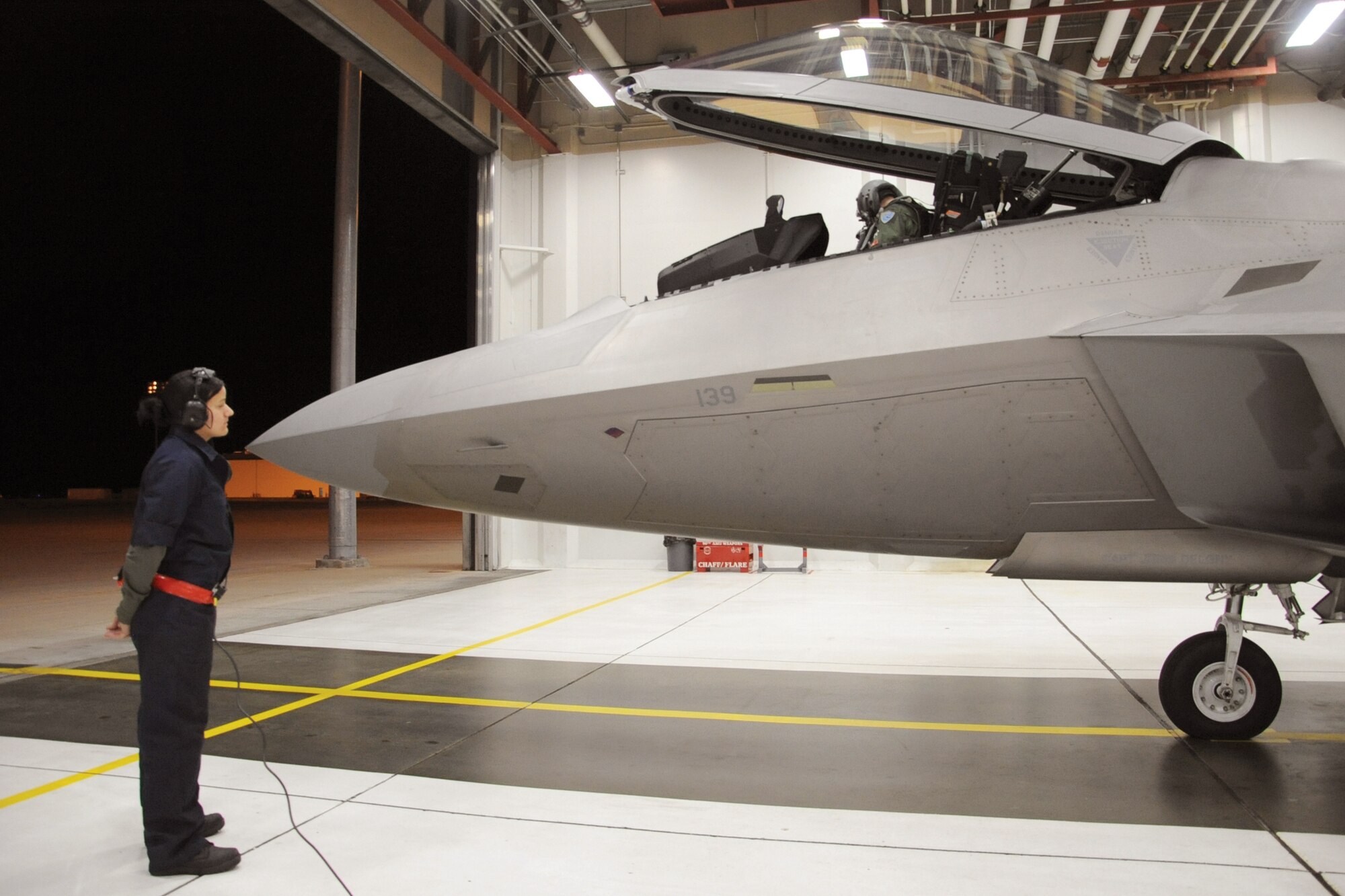 Airman 1st Class Jennifer Craig (left) and Australian Maj. Matthew Harper prepare an F-22 Raptor for departure to Tyndall Air Force Base, Fla., Oct. 30, 2010, from Joint Base Elmendorf-Richardson, Alaska. Airman Craig is assigned to the 90th Aircraft Maintenance Unit and Major Harper is a 90th Fighter Squadron pilot. (U.S. Air Force photo/Senior Airman Cynthia Spalding)