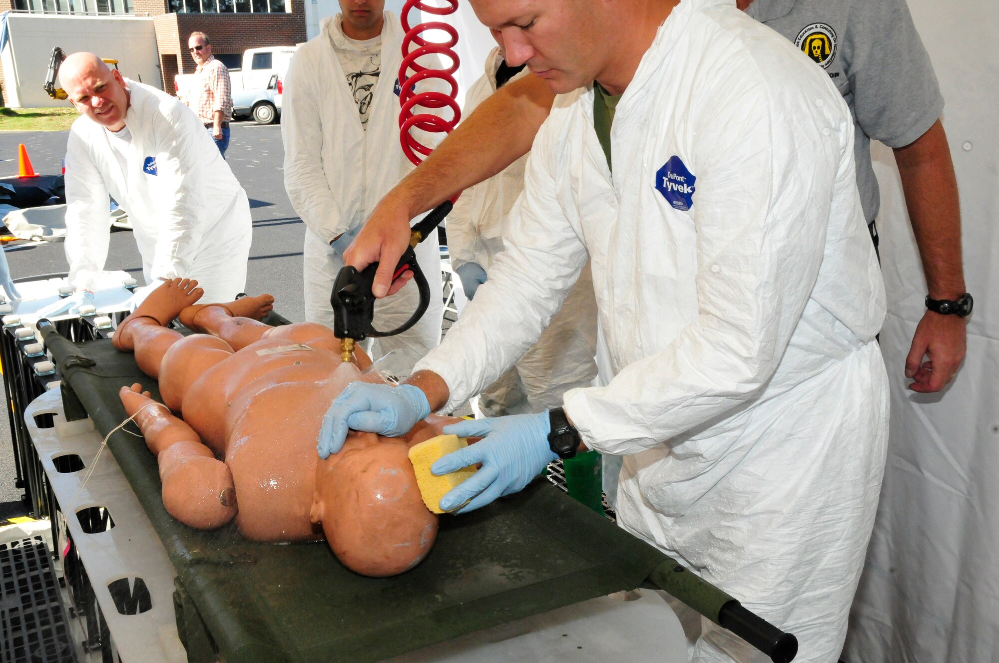 Master Sgt. Jack Atkins, 134 ARW MDG demonstrates how to decontaminate an individual during In-Place Patient Decontamination training.  The training was held at McGhee Tyson Air National Guard Base, Tennessee to better prepare airmen for a real world incident.  McGhee Tyson was the first base to recieve this particular training.  (US Air Force photo by Tech. Sgt. Kendra Owenby,  134 ARW Public Affairs/Released by Capt Gary Taft, 134 ARW PAO)