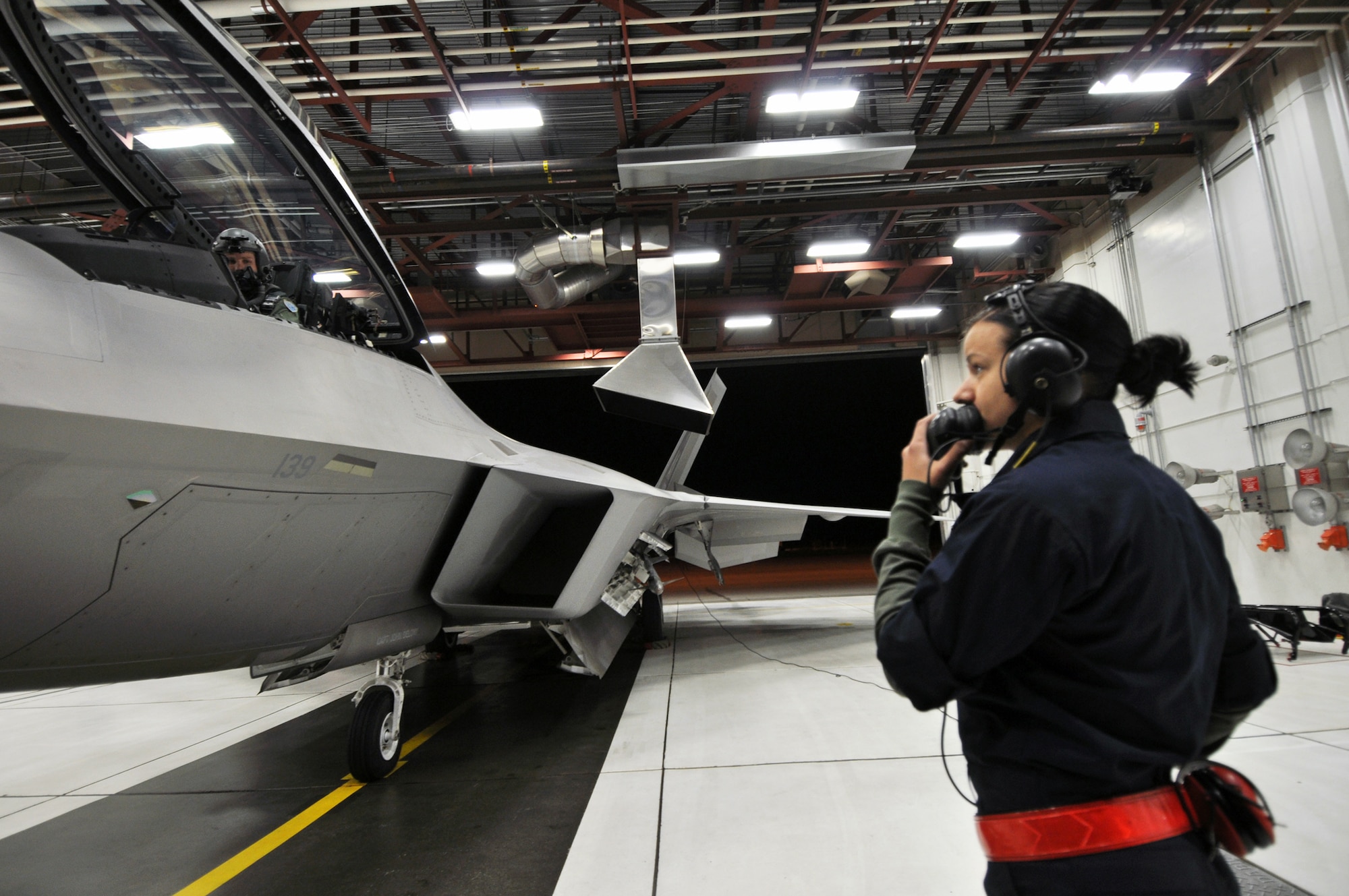 Airman 1st Class Jennifer Craig (left) and Australian Maj. Matthew Harper prepare an F-22 Raptor for departure to Tyndall Air Force Base, Fla., Oct. 30, 2010, from Joint Base Elmendorf-Richardson, Alaska. Airman Craig is assigned to the 90th Aircraft Maintenance Unit and Major Harper is a 90th Fighter Squadron pilot. (U.S. Air Force photo/Senior Airman Cynthia Spalding)