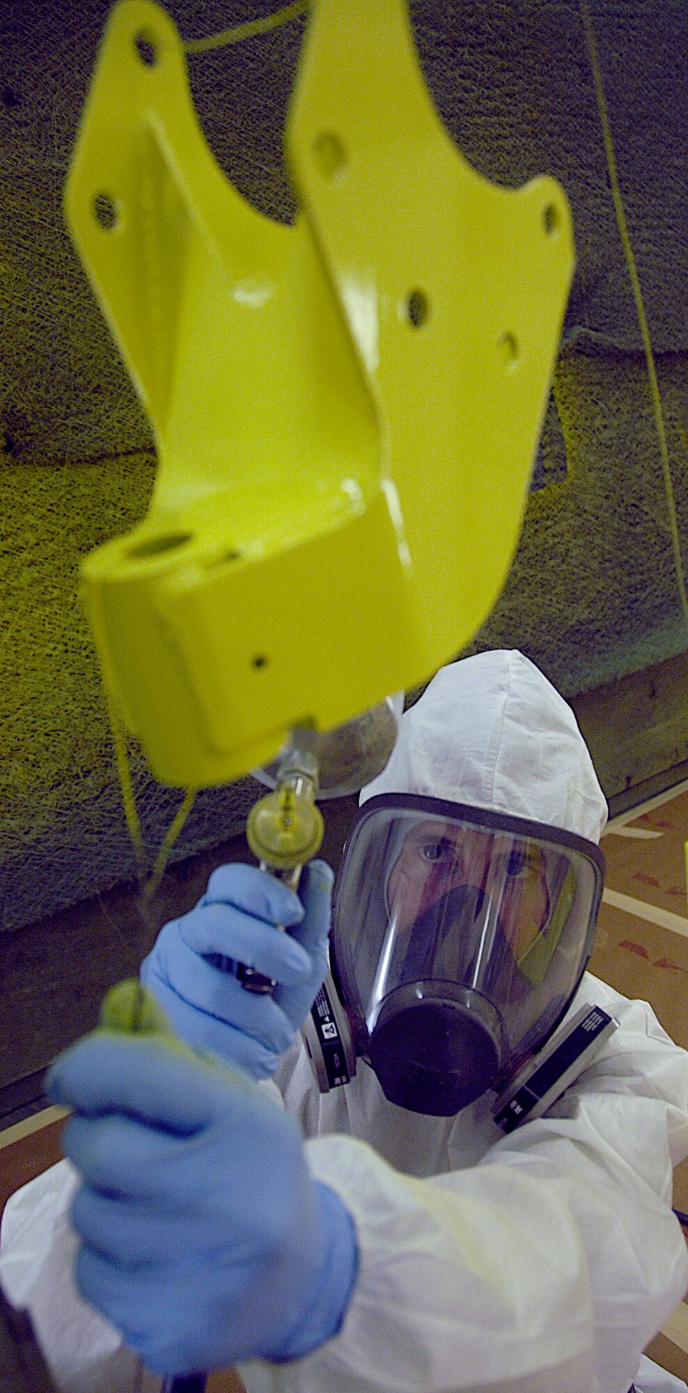 Senior Airman Scott Trombley, aircraft structural maintainer, primers aircraft brackets Aug. 6, 2010. After these brackets dry, they are ready for paint. (U.S. Air Force photo/ Airman 1st Class Natasha E. Stannard)