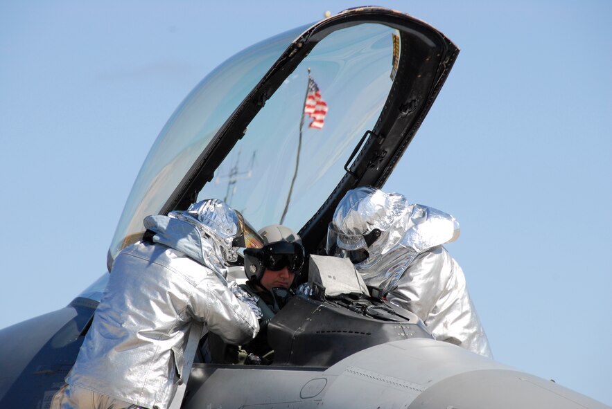 Firefighters from the 148th Civil Engineering Squadron extract a pilot from an F-16 Fighting Falcon during an Operational Readiness Exercise (ORE) in Duluth, Minn., May 14, 2009.  The 148 Fighter Wing is conducting the ORE in preparation for an Operational Readiness Inspection (ORI) in August 2009.  (U.S. Air Force photograph by Senior Master Sgt. Ralph J. Kapustka)