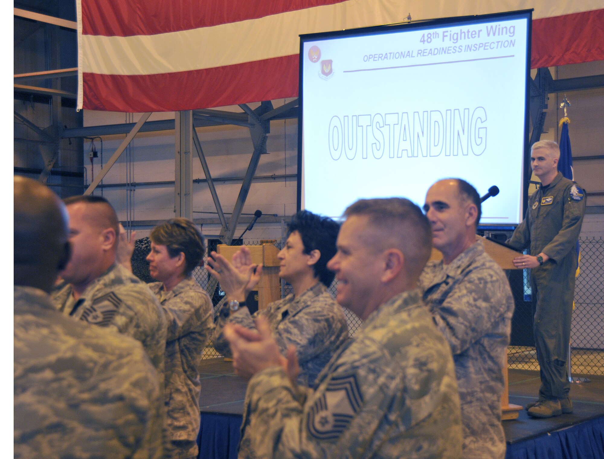 ROYAL AIR FORCE LAKENHEATH, England – 48th Fighter Wing leadership gives a standing ovation to Liberty Airmen after receiving an outstanding rating for the Operational Readiness Inspection in Hangar 6, Nov. 5.  This is the first outstanding rating received by an U.S. Air Forces in Europe base since 1986.  (U.S. Air Force photo/Staff Sgt. Connor Estes